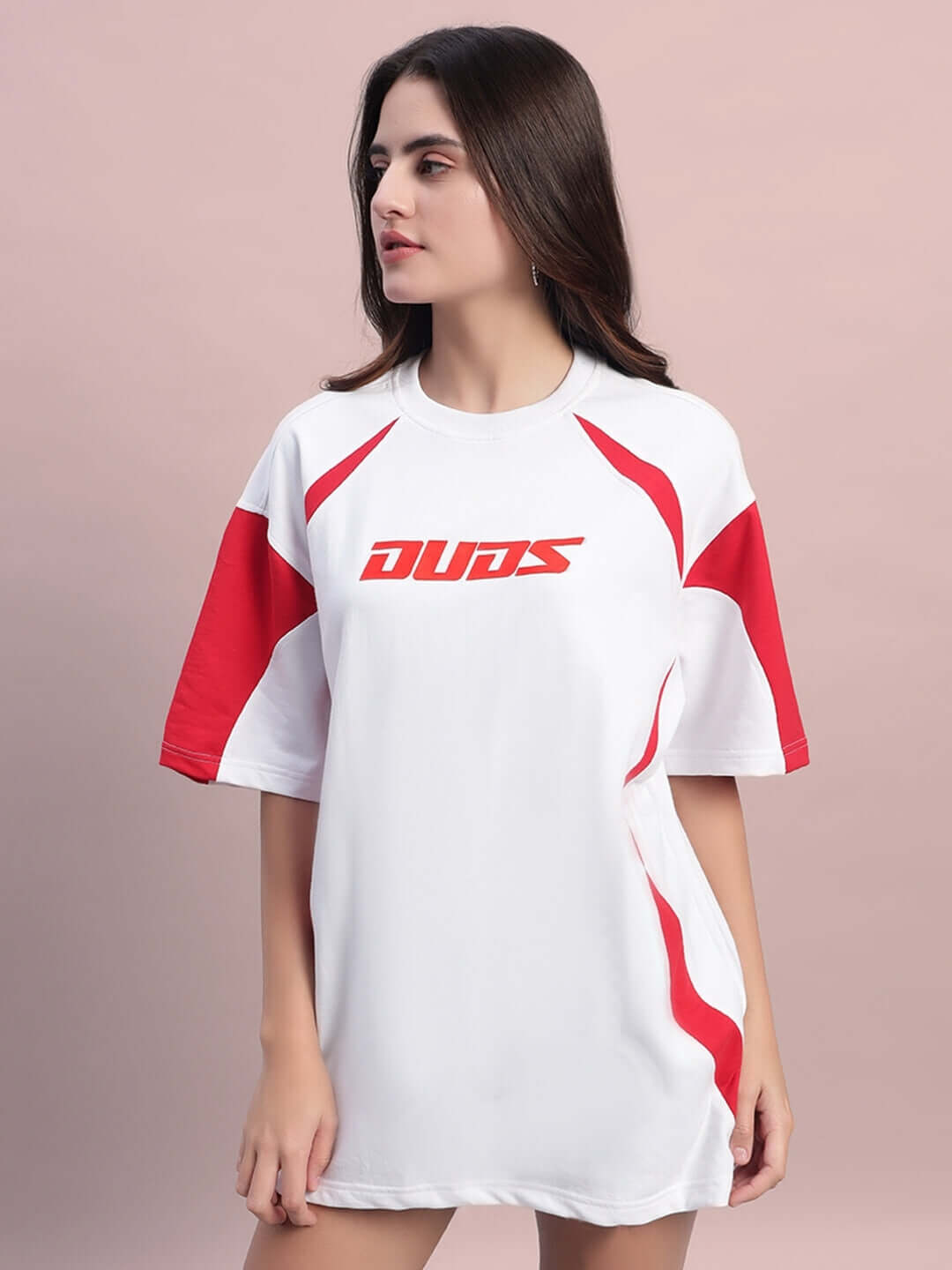 Model wearing women's oversized white and red T-shirt, featuring premium cotton fabric, showcasing casual fashion style.