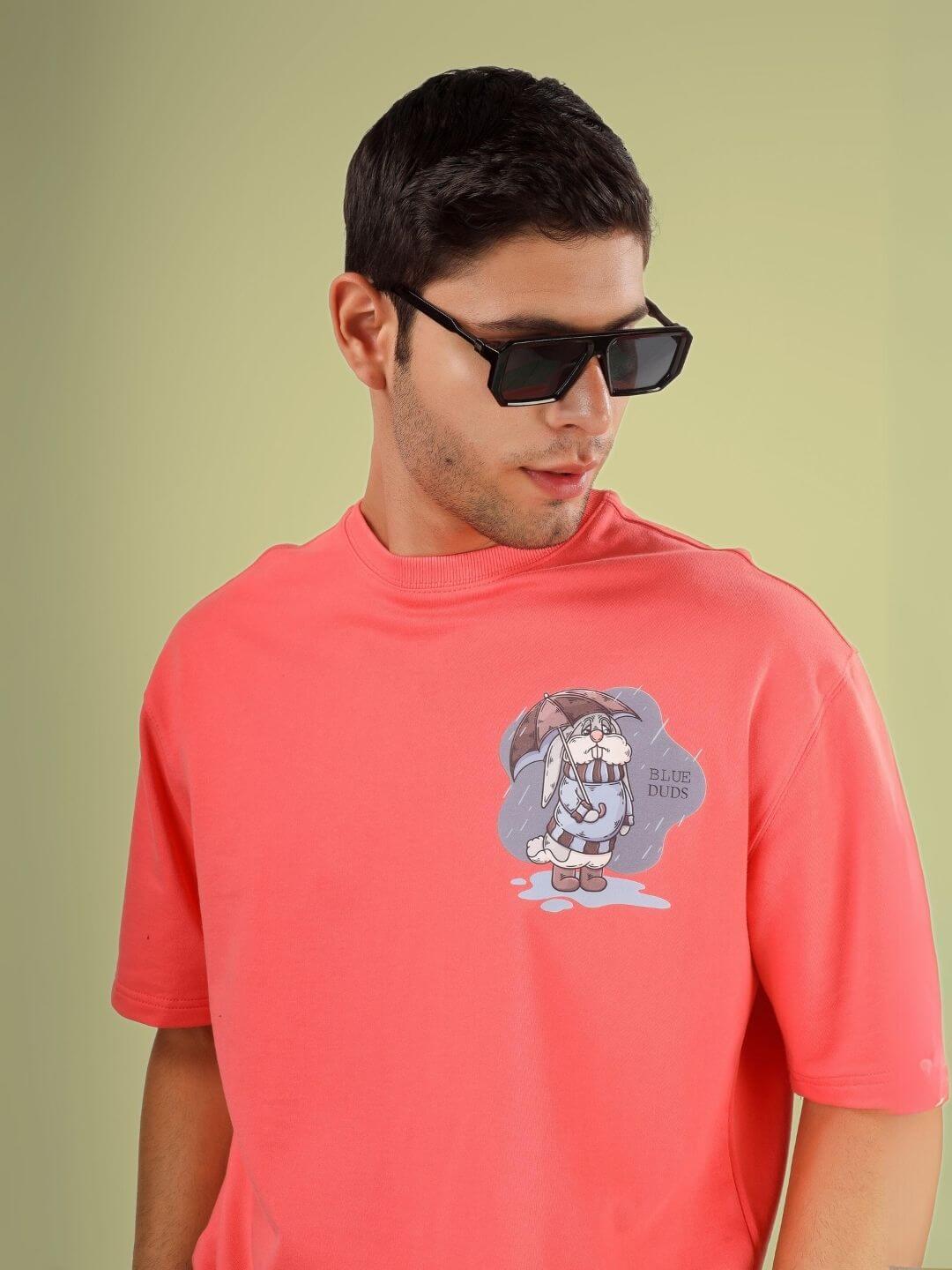 Model wearing BLUE LAPIN OVER-SIZED T-SHIRT PANTONE PEACH with unique print design, made of premium cotton French terry.