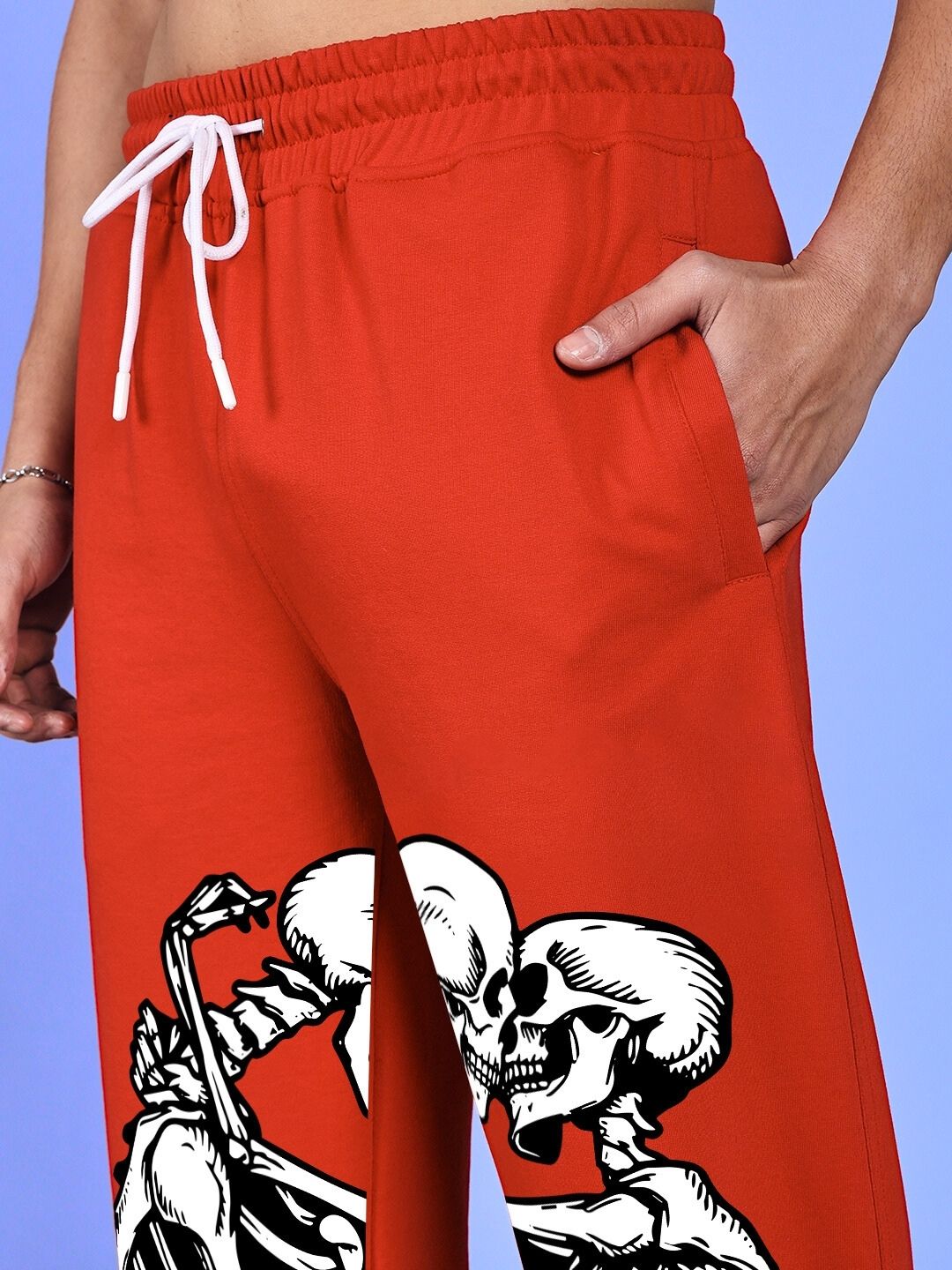SKELETONS LOVE RELAXED FIT JOGGER RED with skeleton design and drawstring waist, perfect for a comfortable and stylish look.