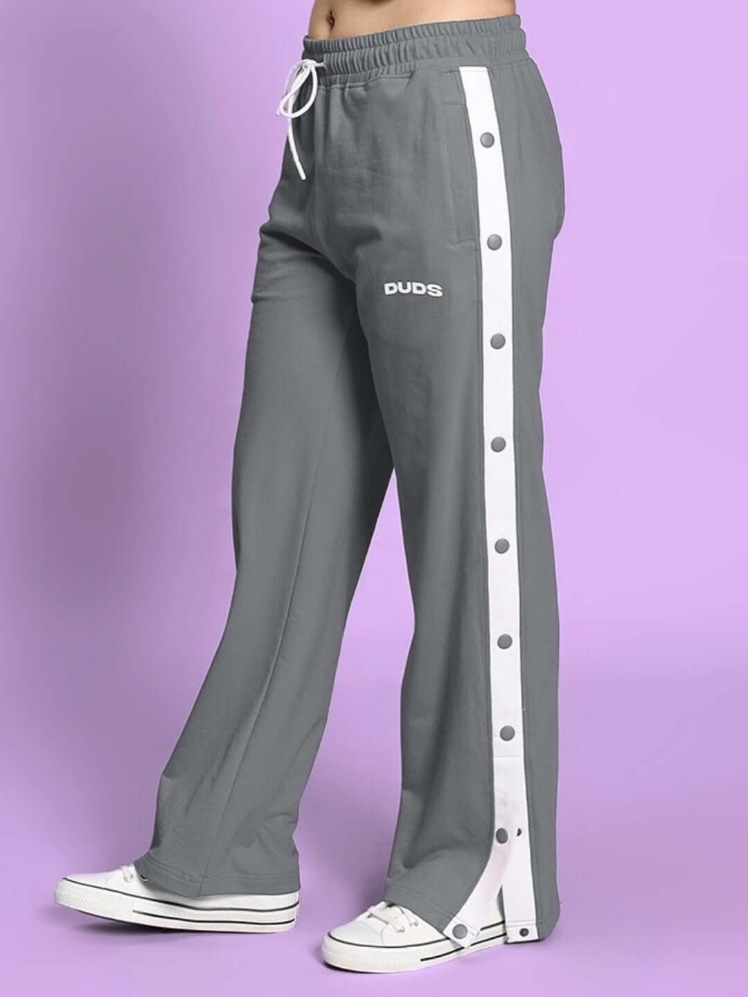 Grey women's relaxed fit jogger with button detail from DUDS, shown in side view on model. Comfortable and customizable.