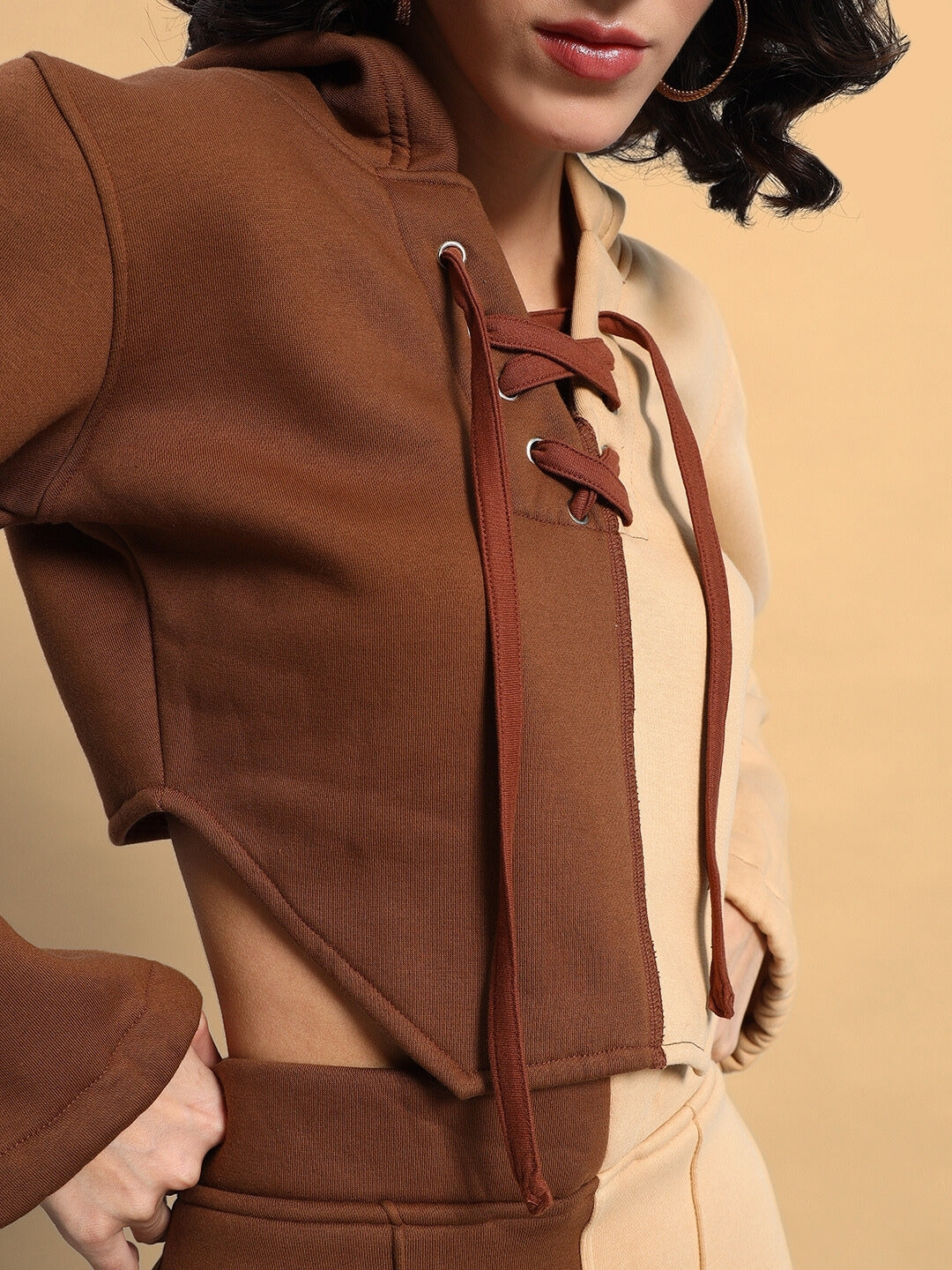 Woman wearing beige-brown Sophia co-ord set with lace-up detail, showcasing chic and comfortable style.
