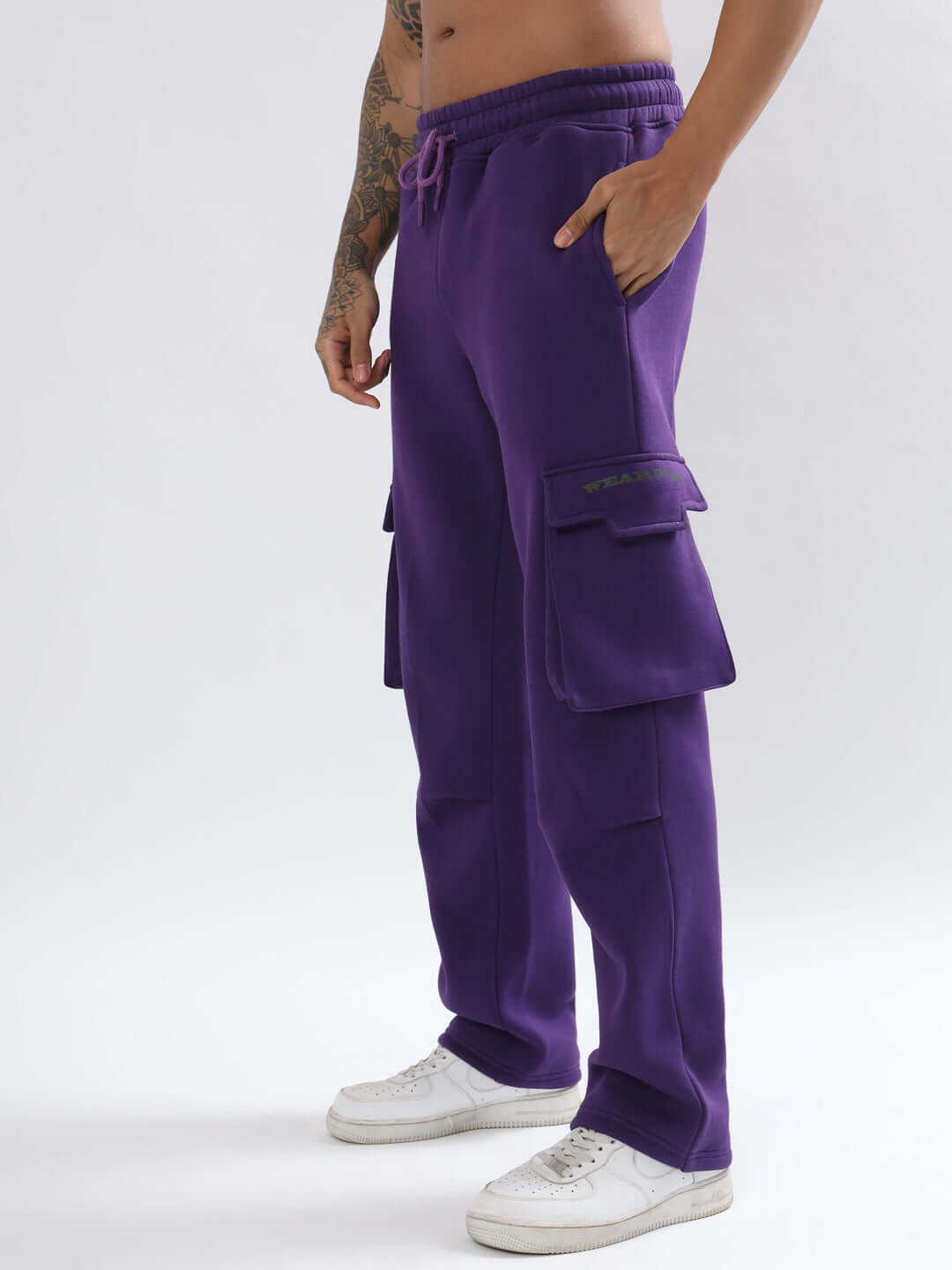 Model wearing 5 POCKET FLEECE SOLID CARGO PANT PURPLE, showcasing five-pocket design and soft fleece fabric for style and comfort.
