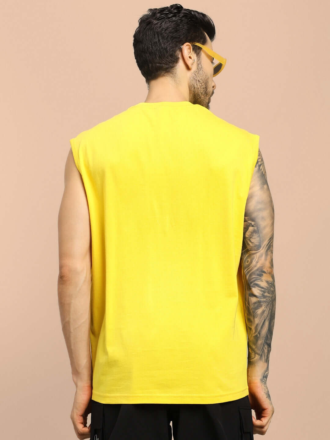 Back view of model wearing yellow STREET LION GYM T-shirt, showcasing its fit and casual style, ideal for workouts.