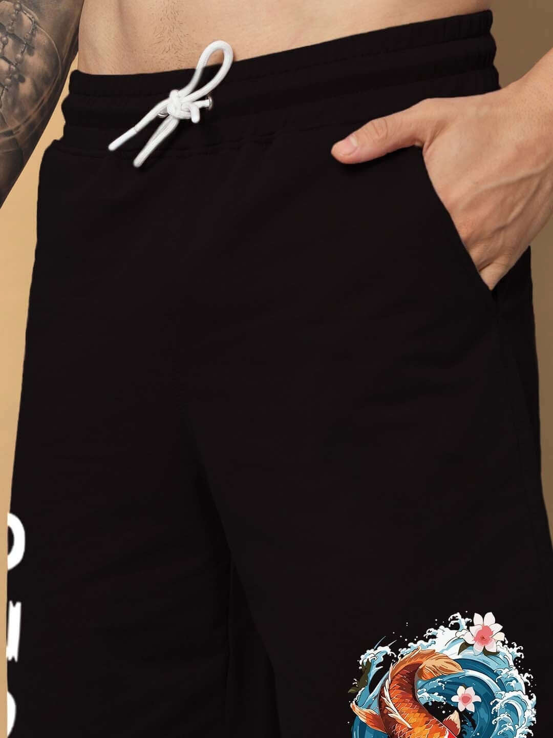 Close-up of MAJESTIC FISH Regular Fit Black Shorts with pocket detail and decorative design.