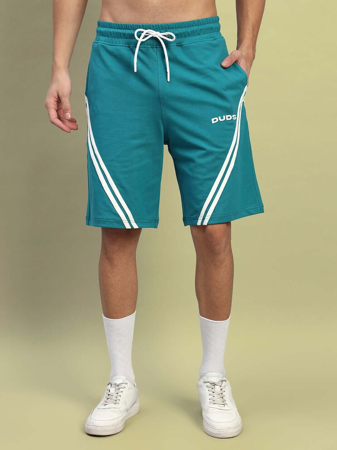 STAR JUMPER regular fit teal shorts with custom fit option, shown on a person wearing white socks and sneakers.