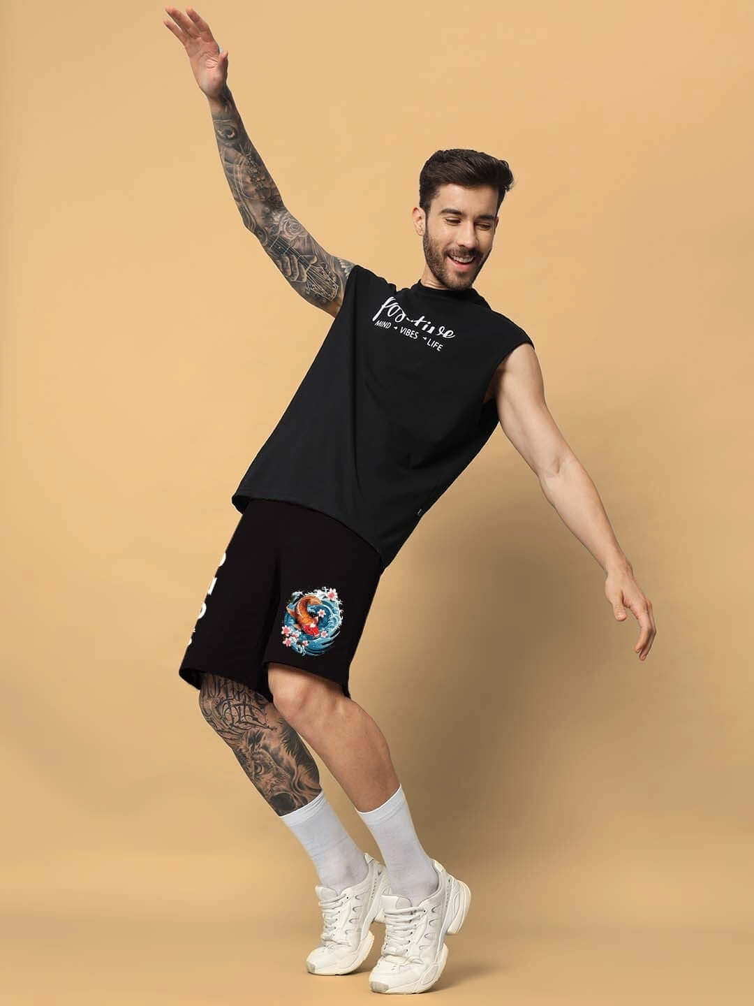 Man wearing Majestic Fish regular fit black shorts, showcasing casual style with a playful pose against a neutral background.
