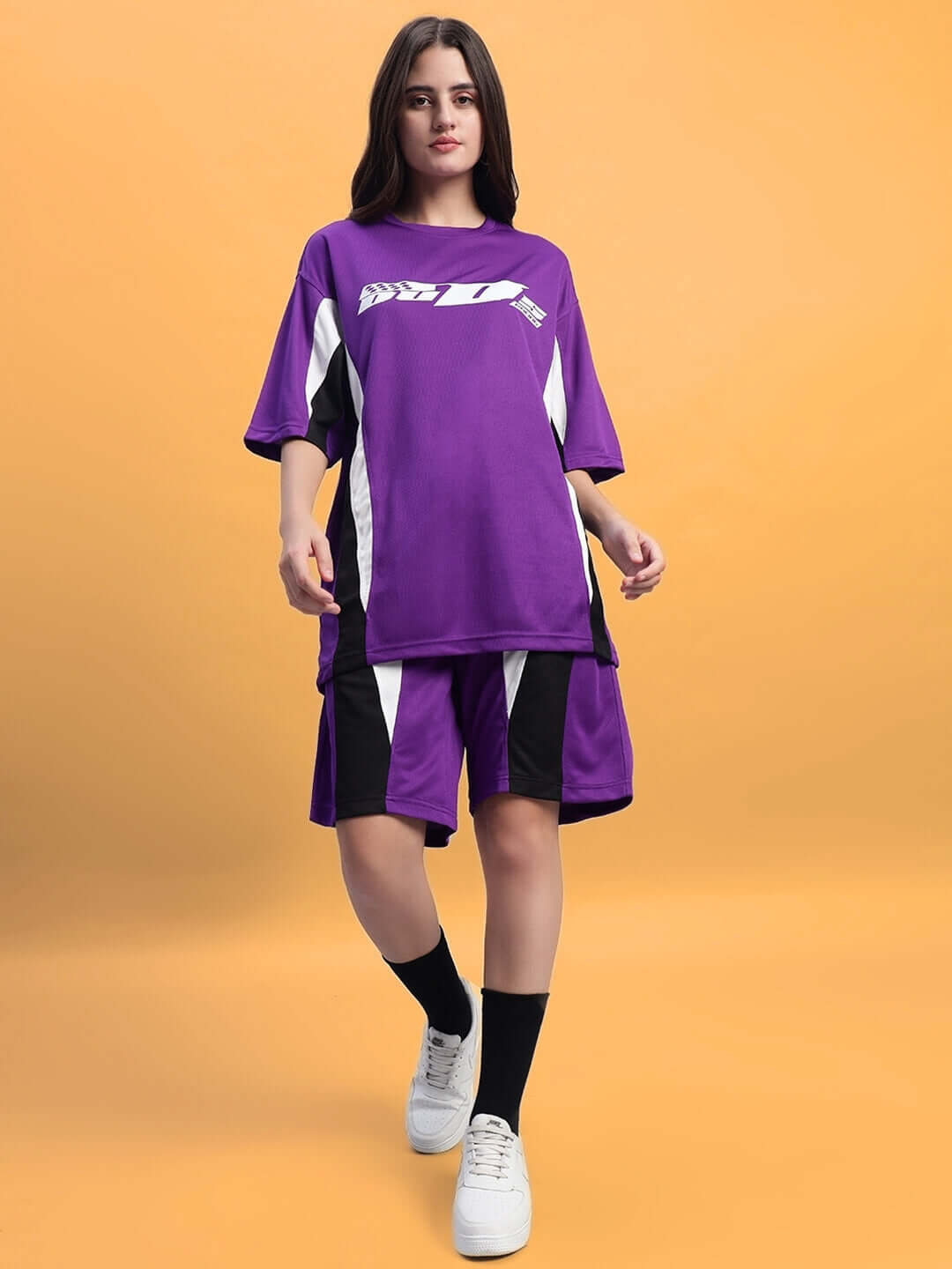 Model wearing women's FIFA colorblock co-ord set in purple, featuring sports polyester fabric.