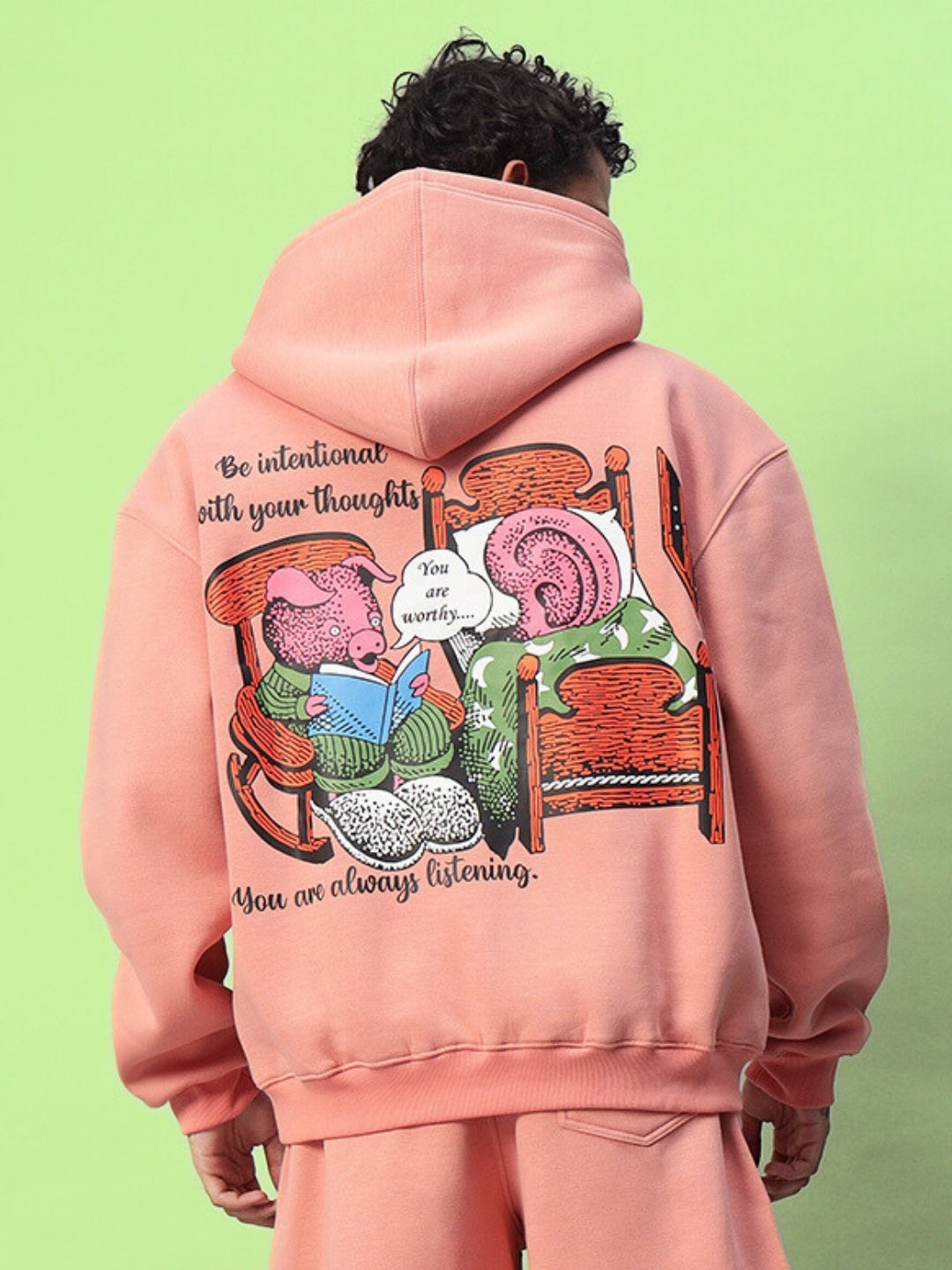 Peach fleece hoodie with a whimsical illustration and motivational text, promoting mindfulness and positivity.
