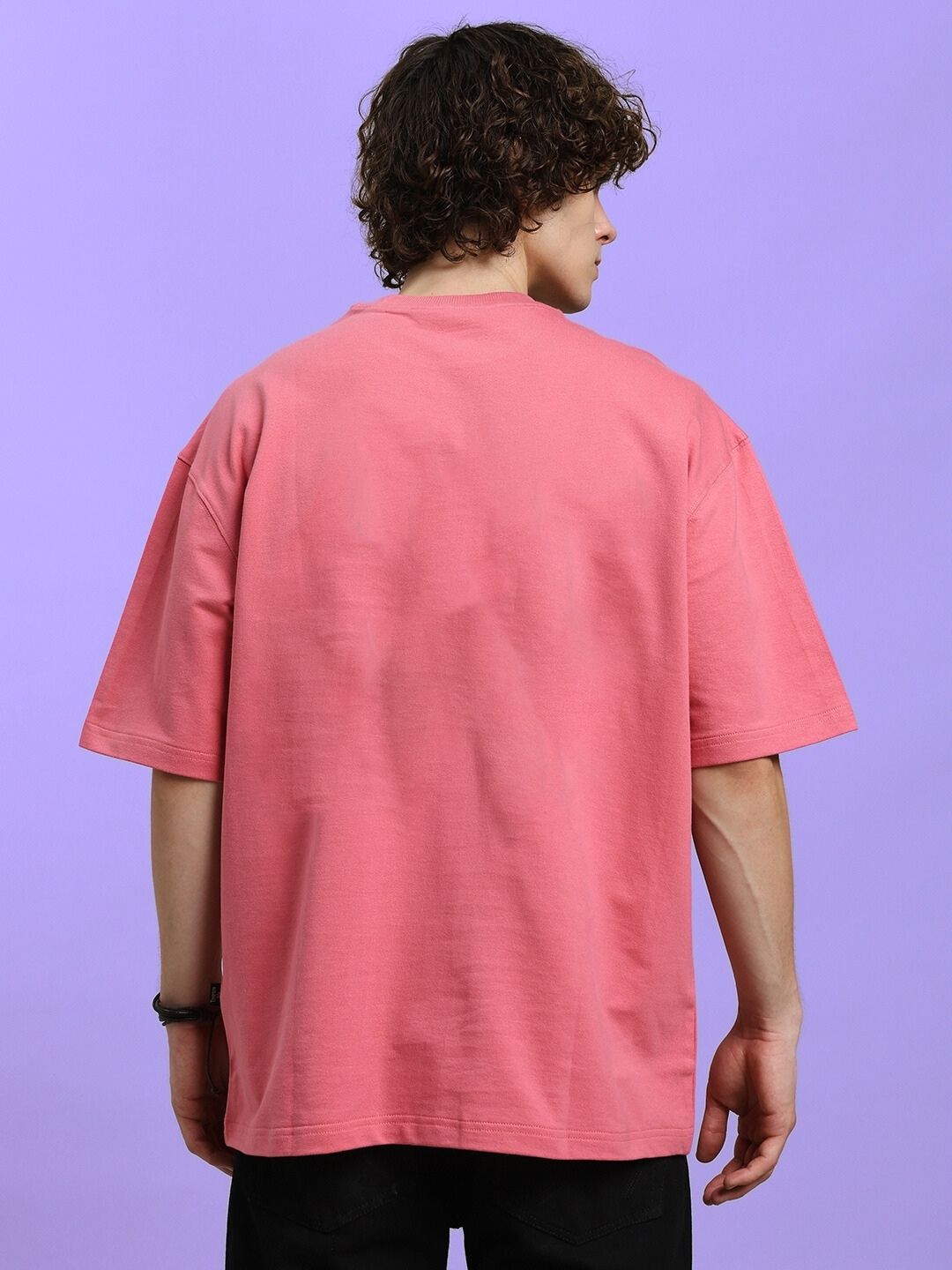 Back view of KITSUNE WOLF PRINTED OVERSIZED T-SHIRT PINK worn by model, showcasing streetwear style and Japanese-inspired design.
