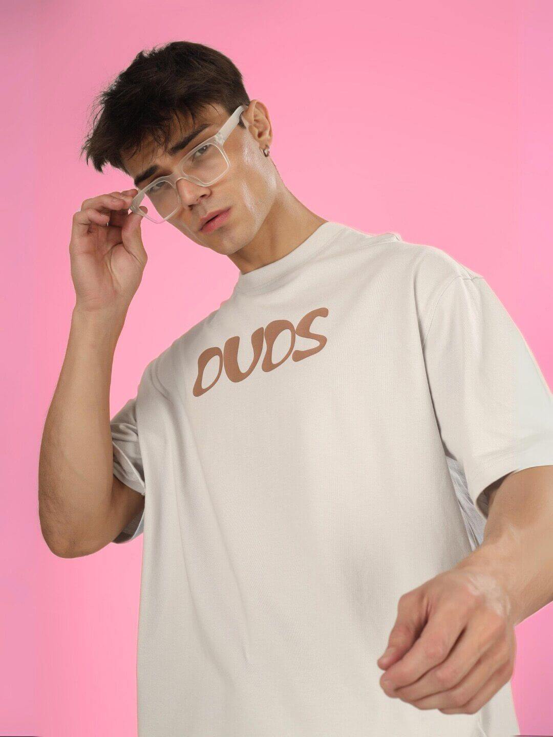Model wearing HIGH AS FUCK OVER-SIZED T-SHIRT BUTTER CREAM, showcasing bold streetwear with relaxed fit and sleek design.