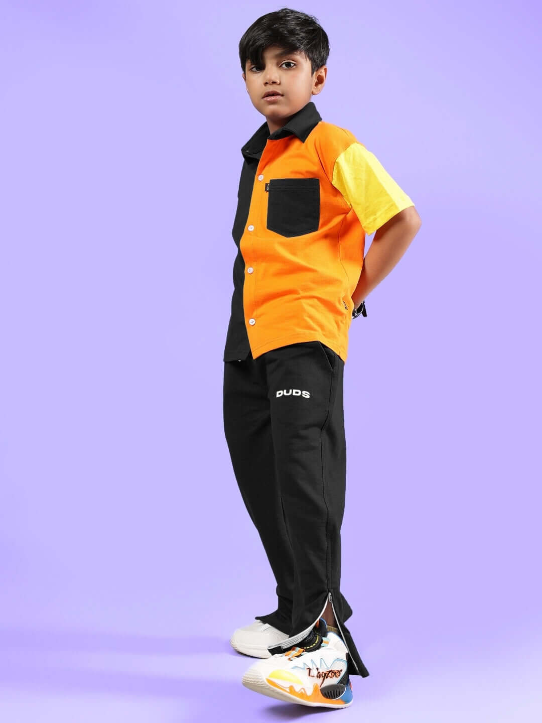 Child wearing APEX co-ord set for boys and girls in orange and black by DUDS, featuring a casual stylish design. Perfect for custom fit orders.