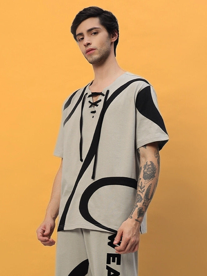 Model wearing a grey oversized surfing designer t-shirt made from premium cotton terry fabric, featuring a unique abstract design.