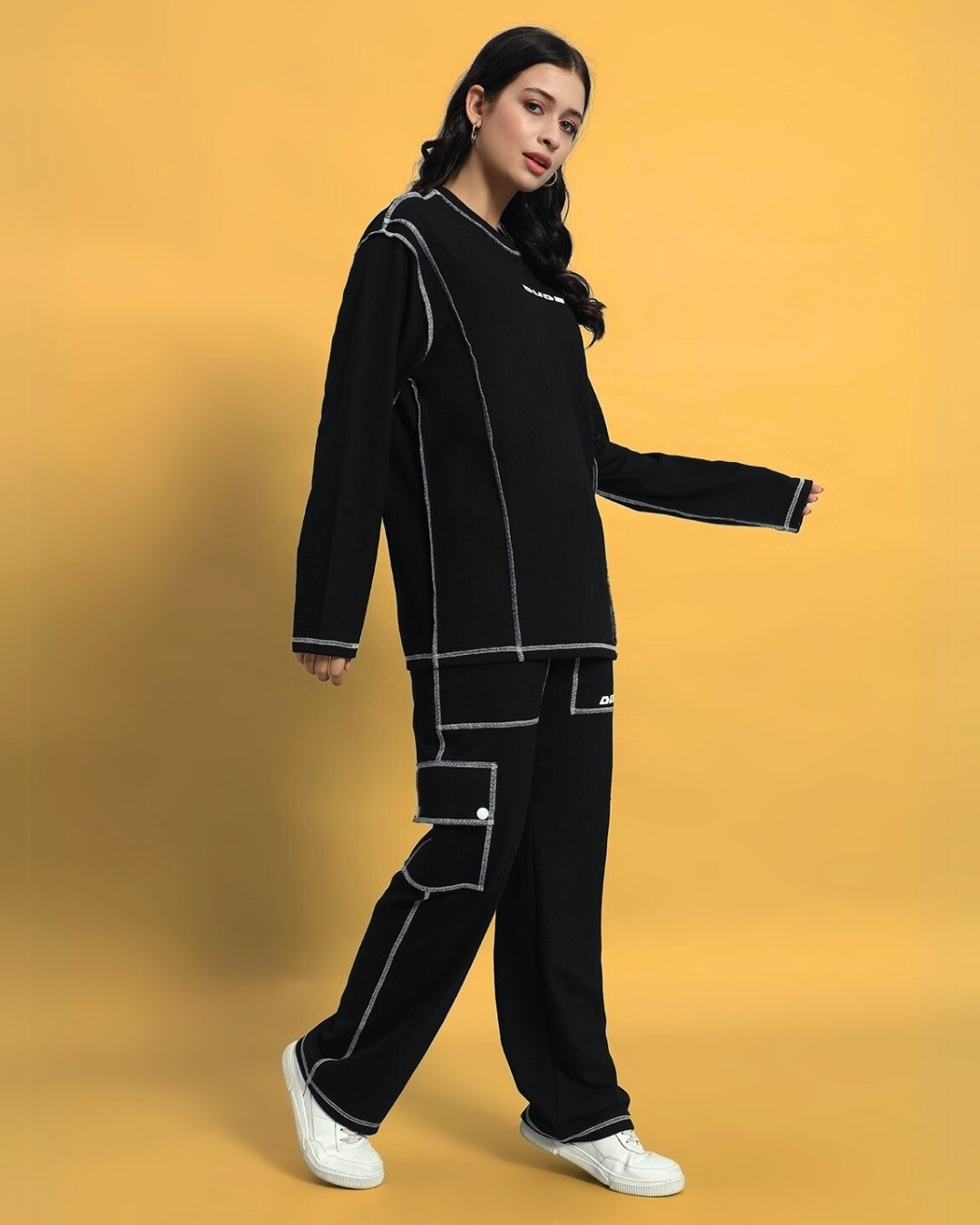 Model wearing Women's Dynamic 5 Pocket Cargo Pant in black, showcasing casual yet stylish design with white stitching details.