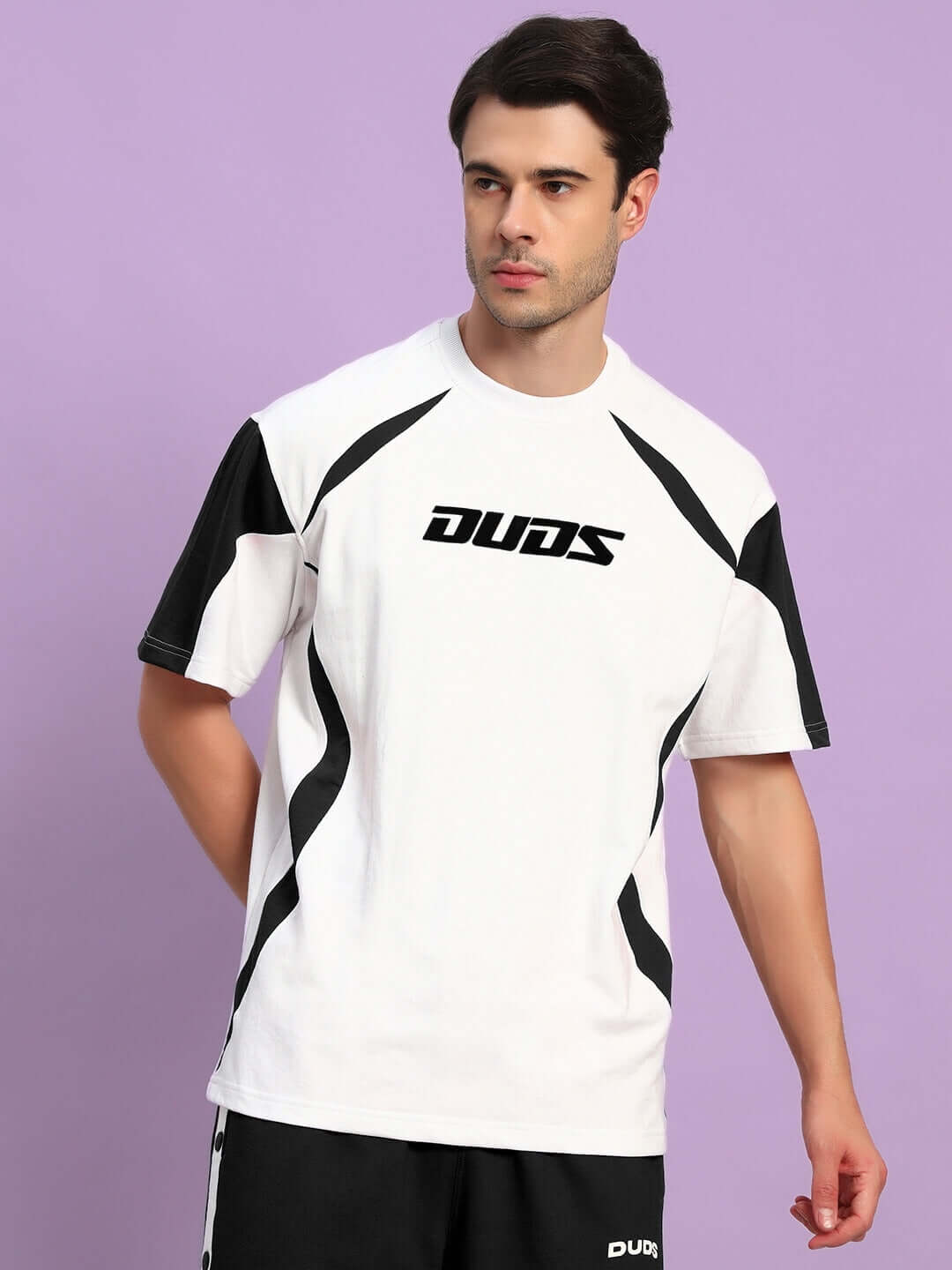 Model wearing Candor oversized white black t-shirt made of premium cotton French terry with elastane, featuring bold design accents.