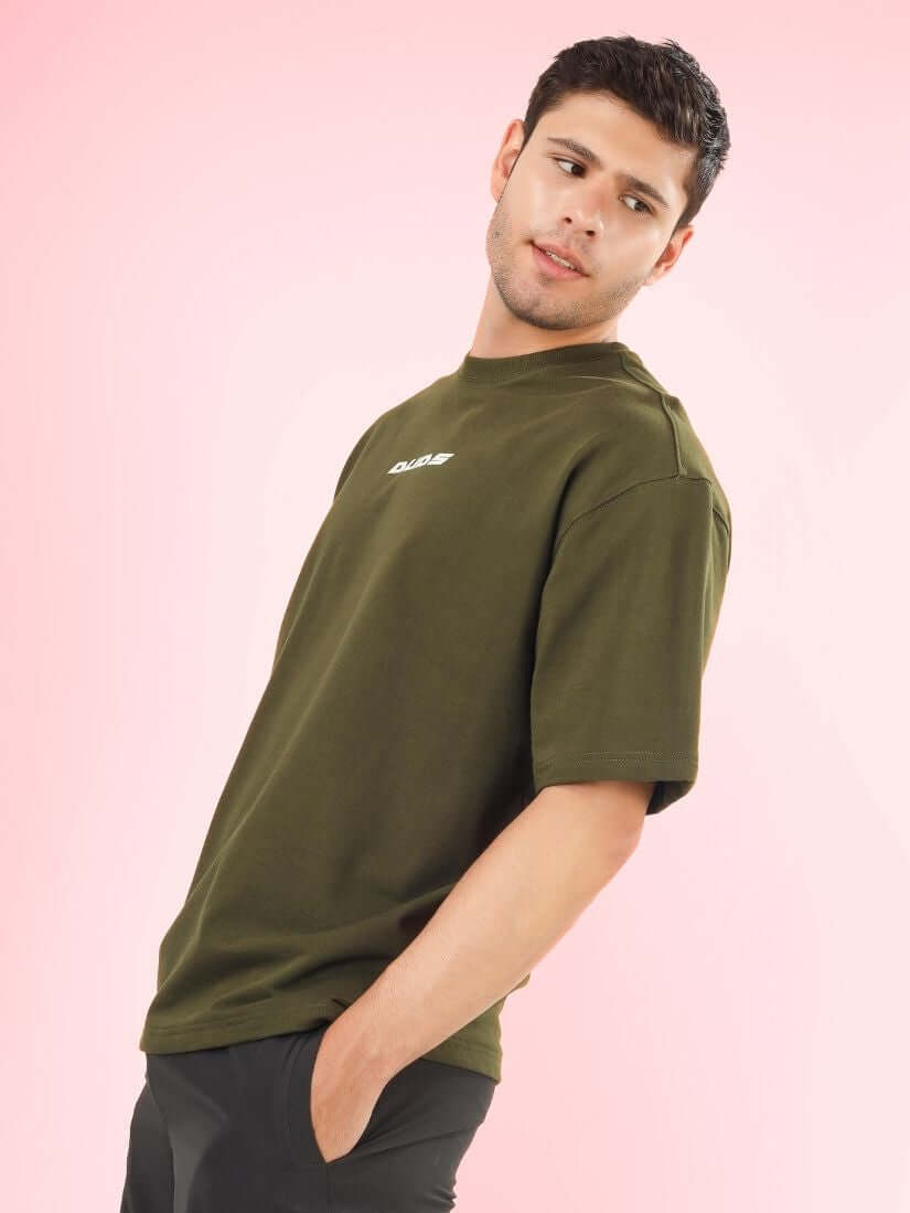 Model wearing AMOUR OVER-SIZED T-SHIRT OLIVE GREEN made from premium cotton French terry and elastane, ideal for comfortable fashion.