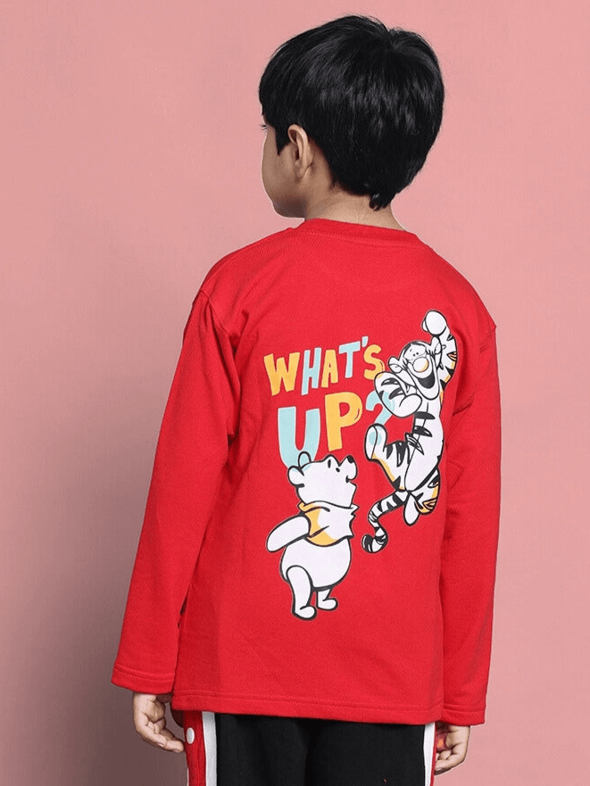 Child wearing red oversized sweatshirt with cartoon characters and 'What's Up' text on the back.