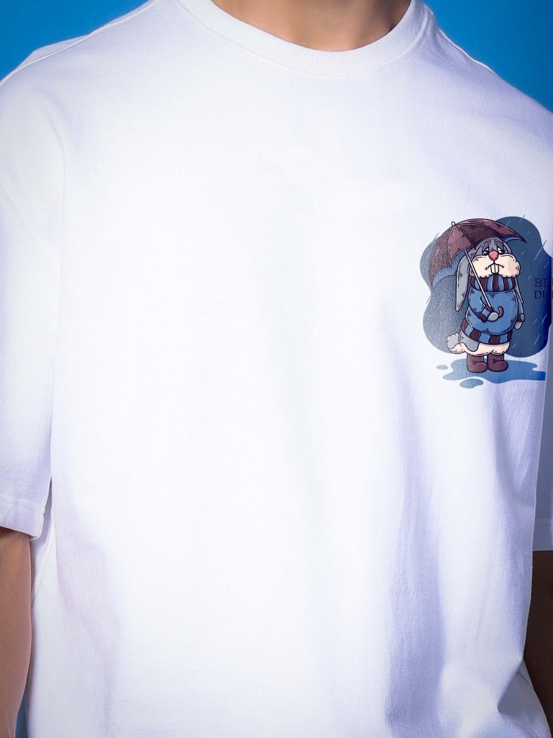 BLUE LAPIN OVER-SIZED T-SHIRT WHITE featuring a cartoon design on premium fabric.