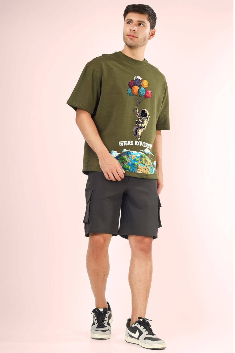 Man wearing FUTURE EXPLORER OVERSIZED T-SHIRT OLIVE GREEN with graphic design