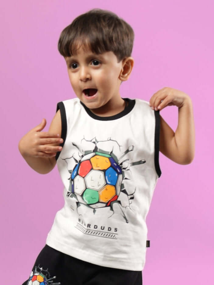 Boy wearing an off-white Lazio t-shirt with colorful soccer ball graphic, suitable for both boys and girls, made by DUDS, on a pink background.