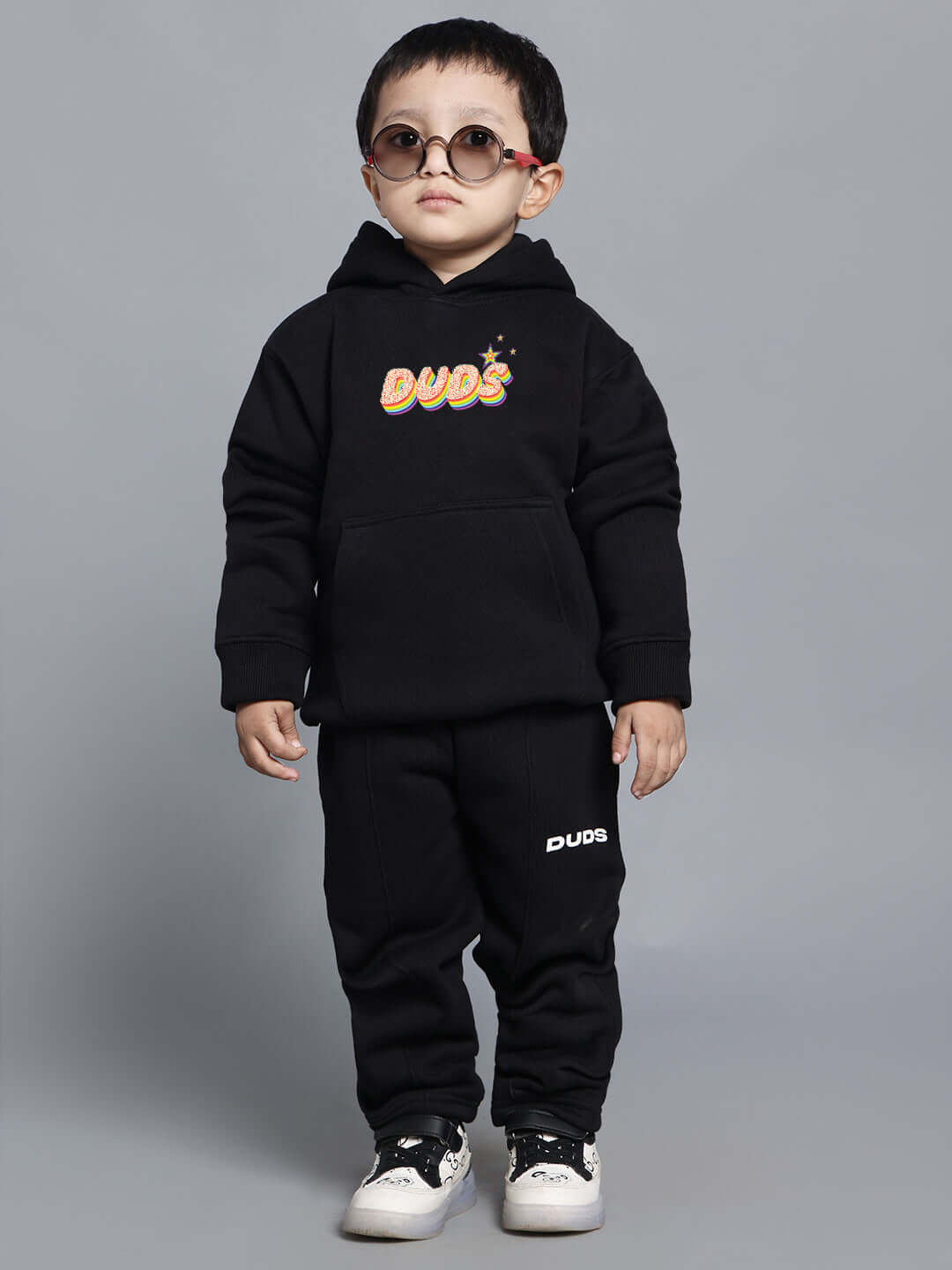 Child wearing "Born to Shine" black co-ord set including hoodie and pants, suitable for boys and girls, stylish unisex outfit.