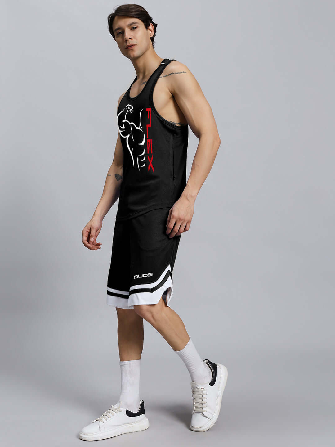 Man wearing FLEX Gym Co-Ord Set in black, made of sports polyester, ideal for workouts, includes tank top and shorts.