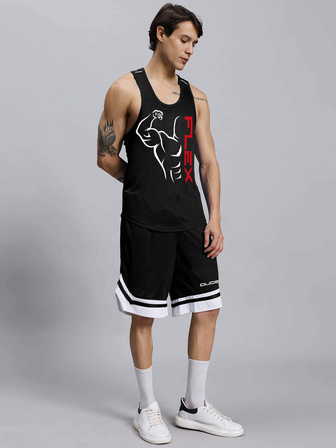 Man wearing FLEX gym co-ord set in black sports polyester, featuring a tank top and shorts, showcasing a fitness-inspired design.