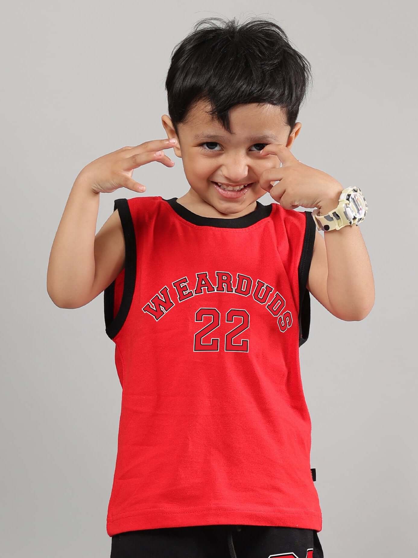 Child wearing red Amiga t-shirt with "Wearduds 22" print, smiling playfully. Perfect for boys and girls. Custom size options available.
