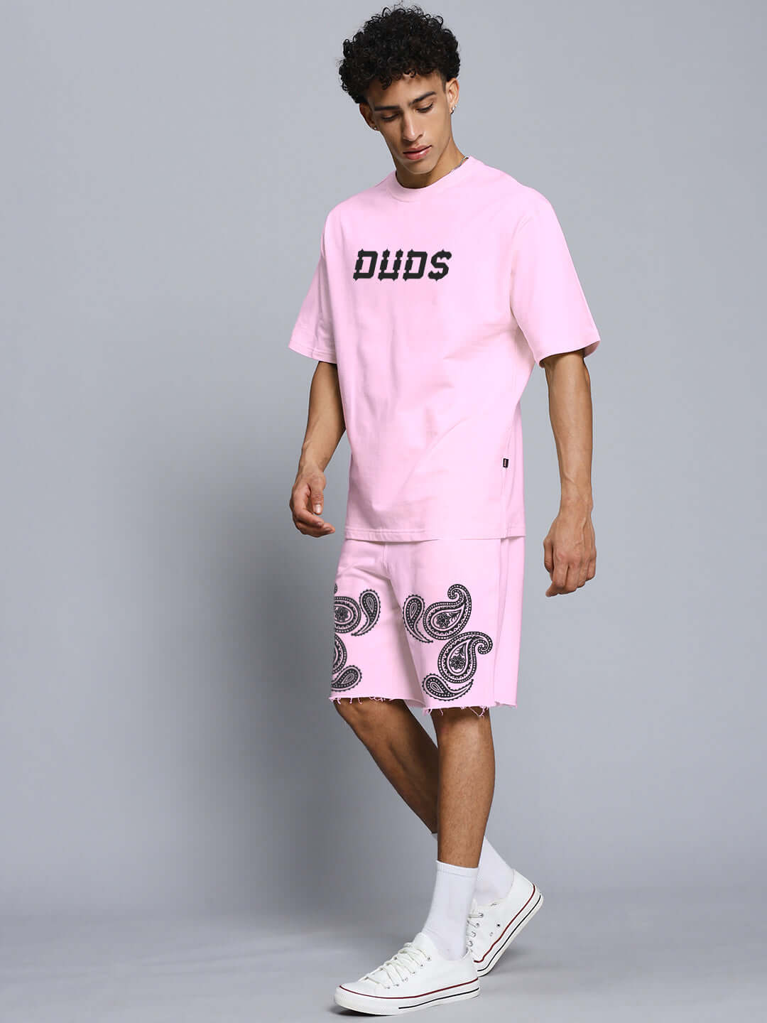 Man wearing Messi paisley print pink co-ord set, featuring premium cotton fabric, showcasing stylish Duds logo and paisley details.