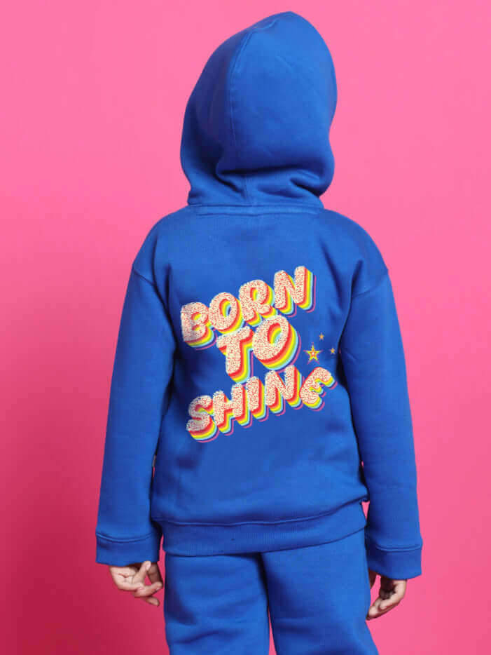 Child wearing blue 'Born to Shine' co-ord hoodie for boys and girls, pink background.