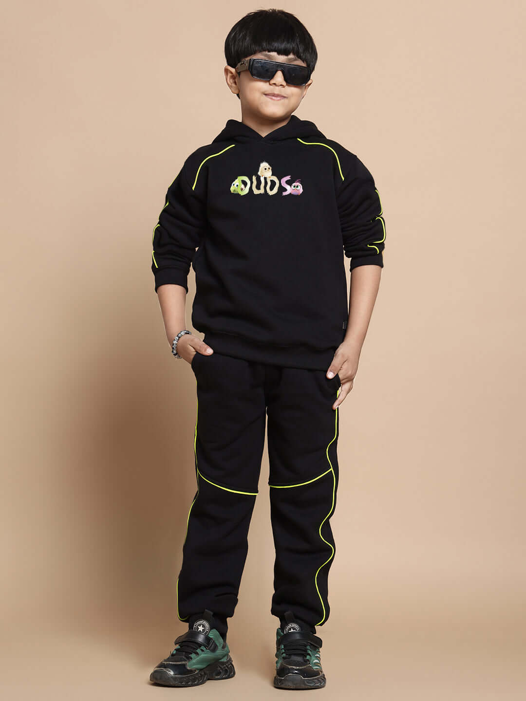 Boy wearing black Angry Bird fleece co-ord set with neon accents, suitable for both boys and girls.