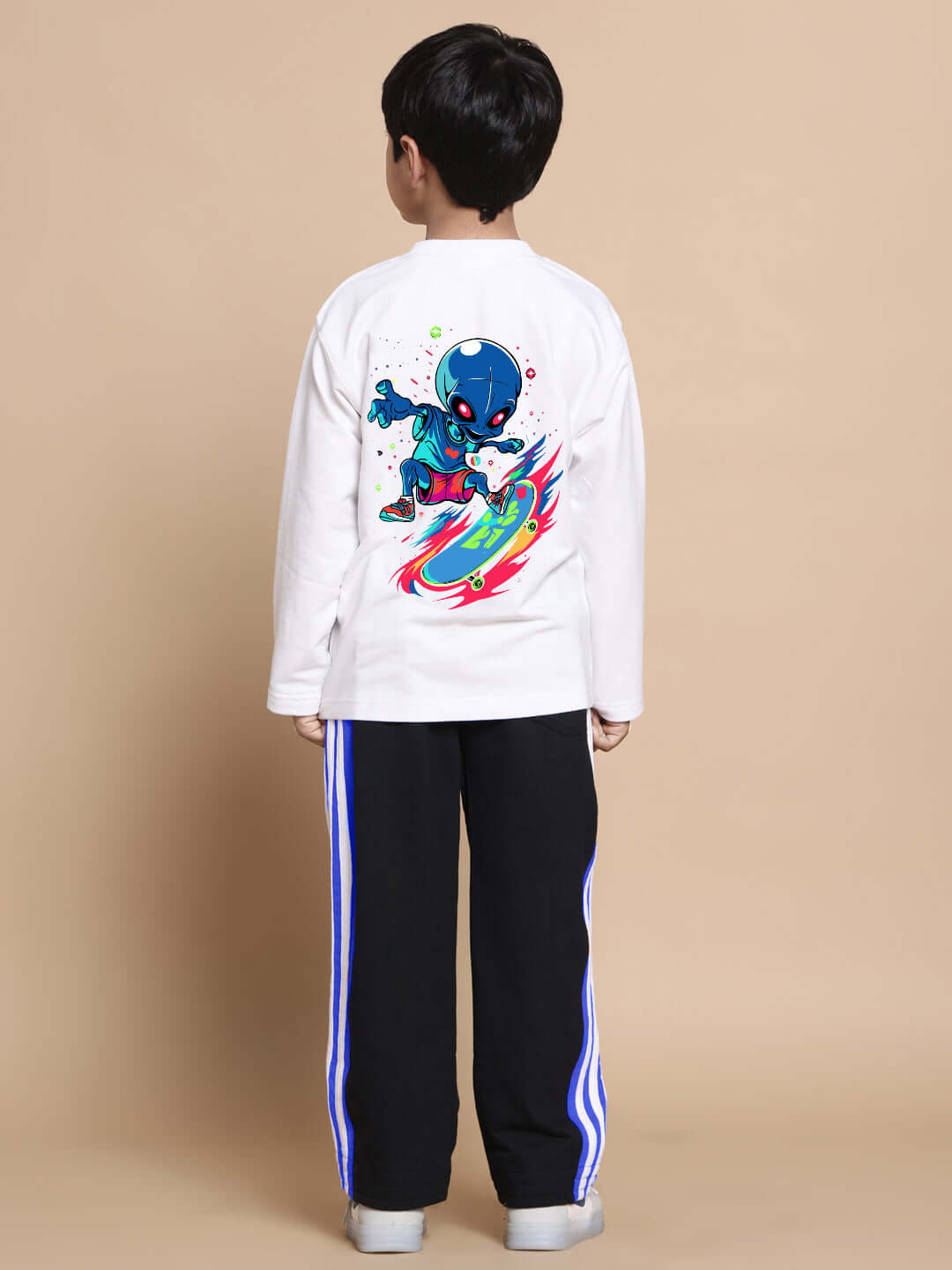 Child wearing an Alien Co-Ord set in white and black, featuring vibrant alien graphic, suitable for boys and girls. Custom fit available.