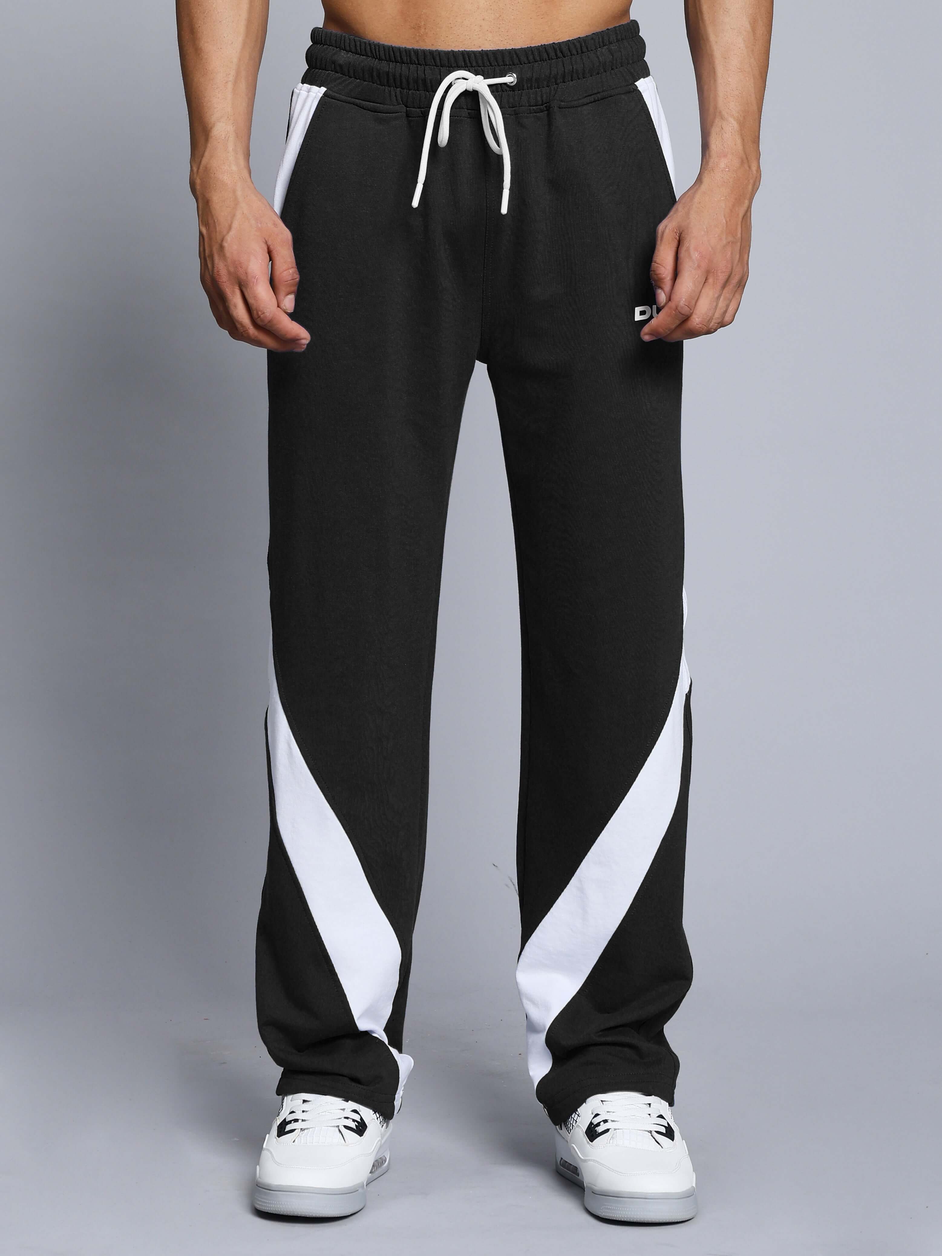 Unisex relaxed fit joggers in black and white, featuring an elasticated waistband with drawstring for a customizable fit.