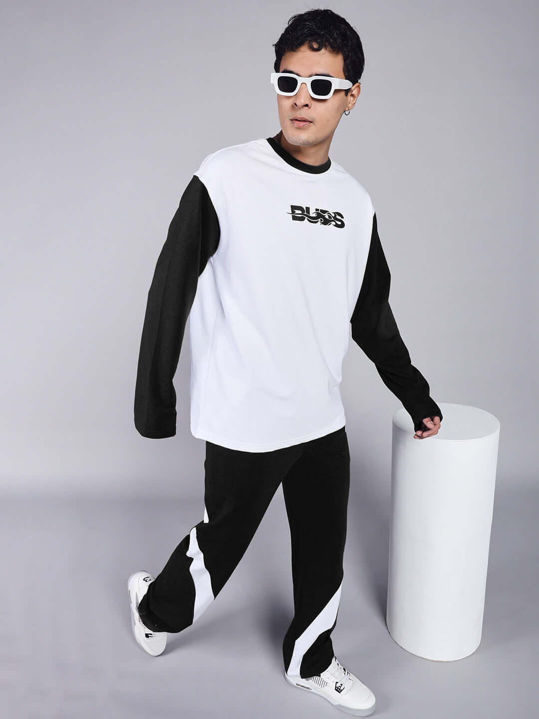 Model wearing CELESTINE Cool Relaxed Fit Co-Ord Set in white-black with unisex joggers and long sleeves, showcasing casual streetwear fashion.