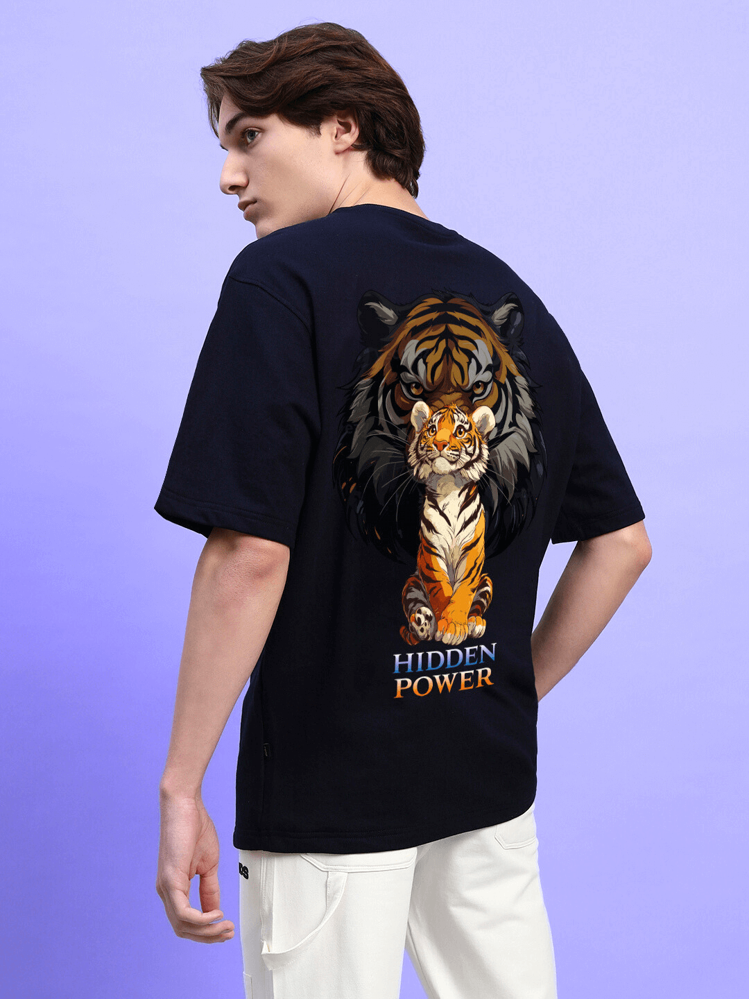 HIDDEN POWER PRINTED OVERSIZED T-SHIRT BLACK with bold tiger graphic, worn by model on a purple background, showcasing streetwear style.