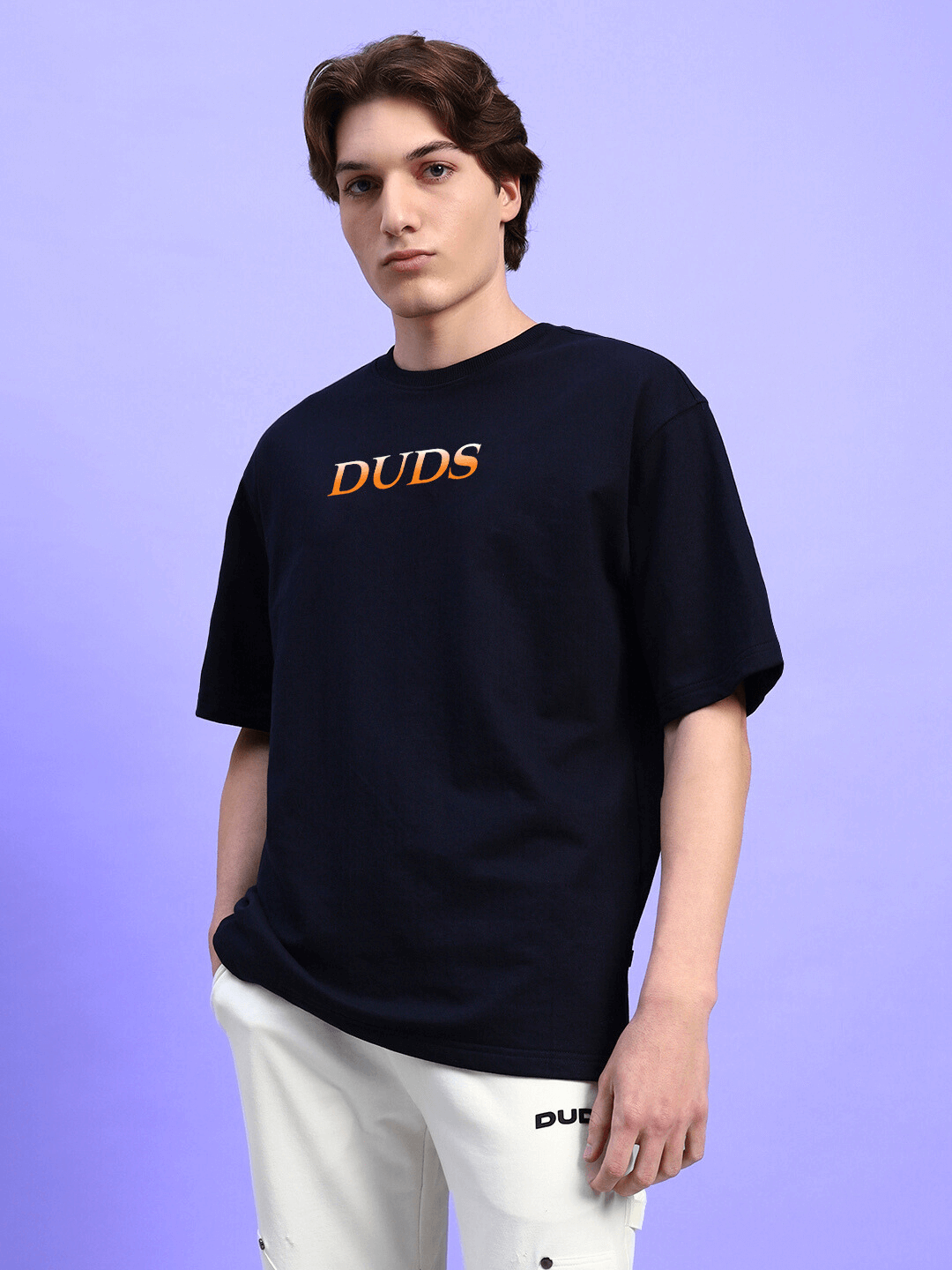 Man wearing HIDDEN POWER PRINTED OVERSIZED T-SHIRT BLACK, featuring bold design for streetwear style.