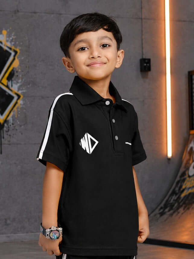 CHAMPION TRACK POLO T-SHIRT FOR BOYS GIRLS BLACK worn by a smiling boy in a stylish pose.