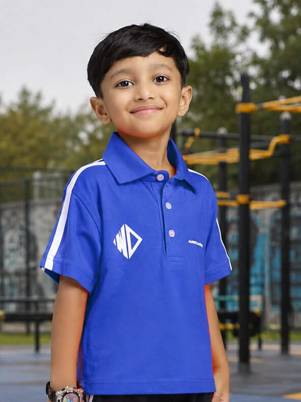 CHAMPION TRACK POLO T-SHIRT FOR BOYS GIRLS BLUE worn by a boy, showcasing vibrant blue color and sporty design.