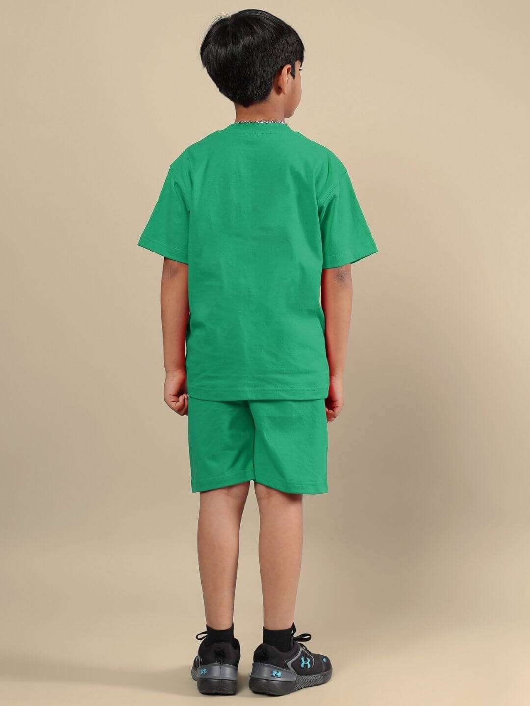 Child wearing ACE CO-ORD FOR BOYS AND GIRLS GREEN, showing back view of the outfit.
