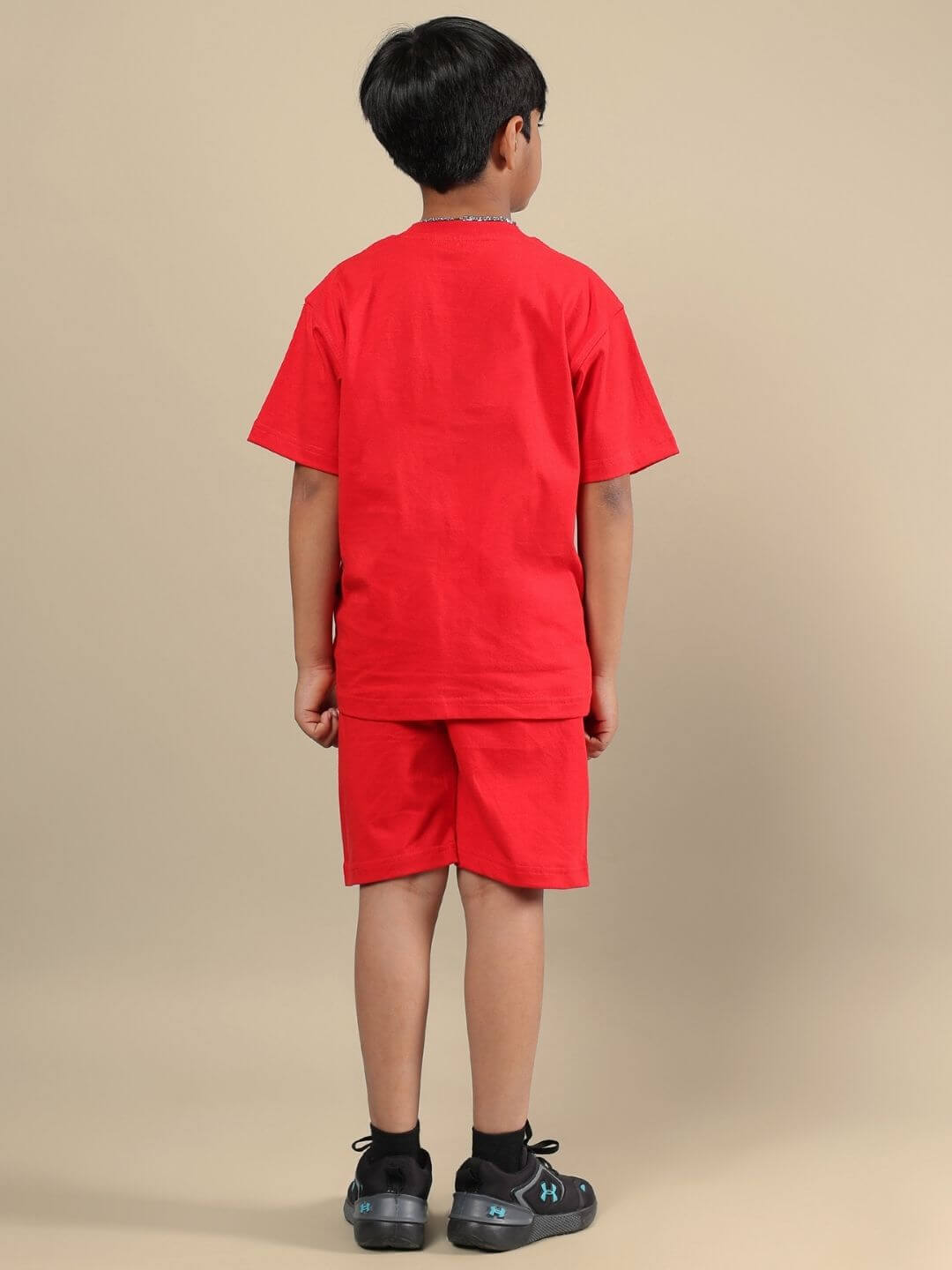 Child wearing the ACE CO-ORD FOR BOYS AND GIRLS RED set, showcasing the vibrant cool style and comfortable fit from the back view.