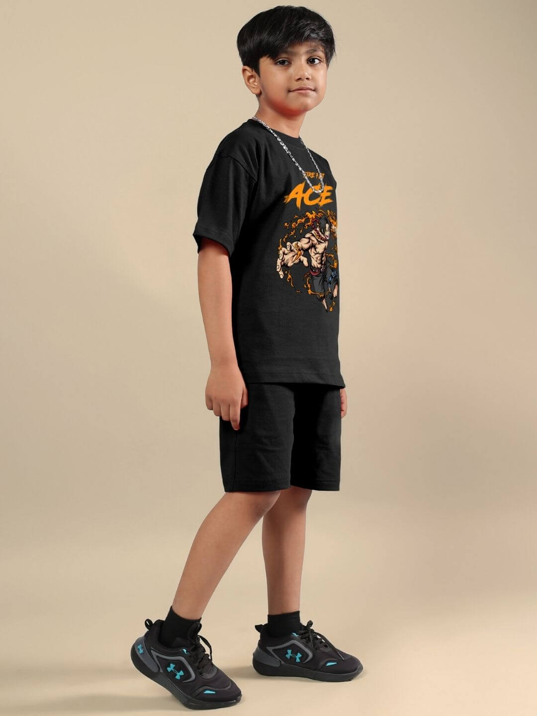 Child wearing ACE CO-ORD FOR BOYS AND GIRLS BLACK matching set, featuring t-shirt and shorts, styled for a trendy and comfortable look.