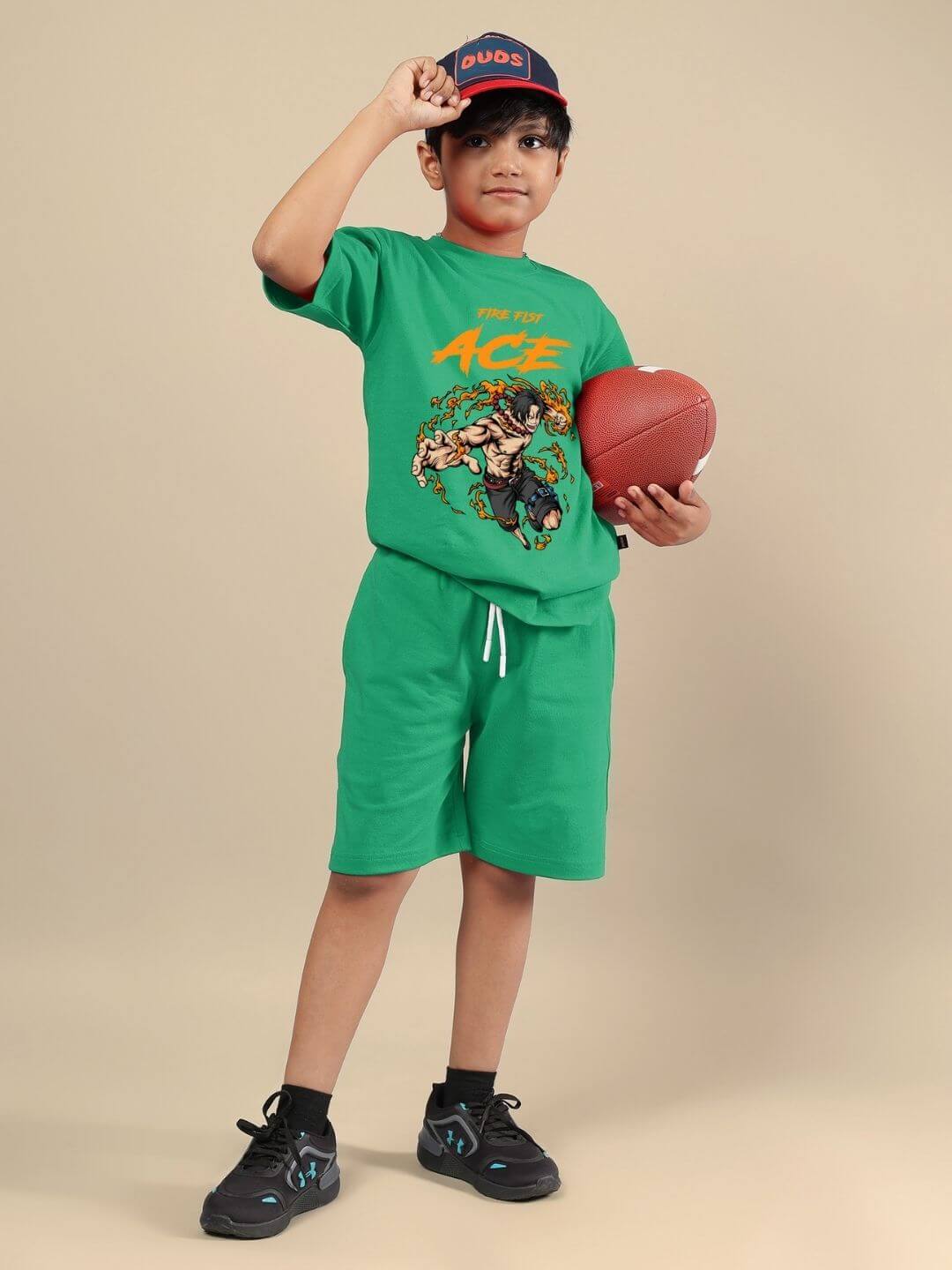 Child wearing vibrant green ACE co-ord set, holding football, showcasing comfortable and stylish unisex outfit for kids.