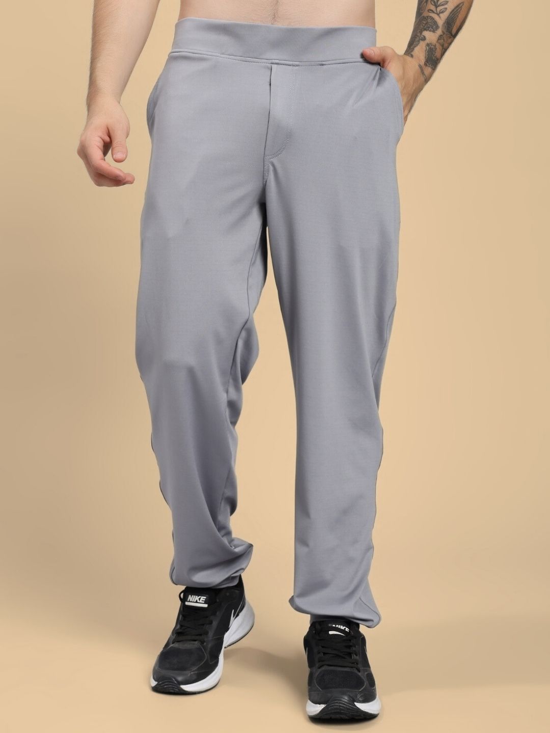 Man wearing ACTIVE FLEX RELAXED FIT JOGGER GREY with black sneakers, showcasing comfort and style for workouts and casual wear.