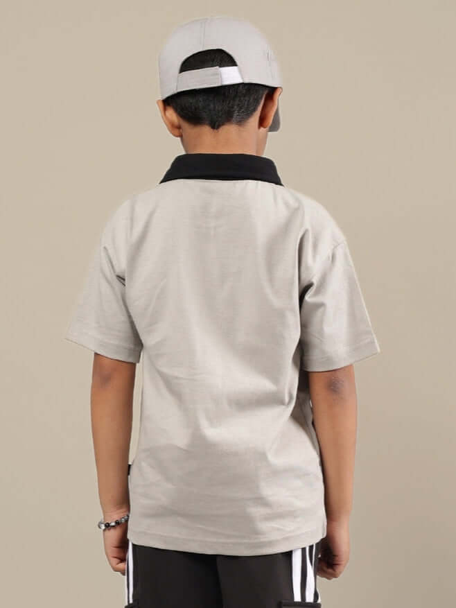 Back view of a child wearing a grey and black shirt, illustrating the comfortable design of ADORABLY shirt for boys and girls by DUDS.