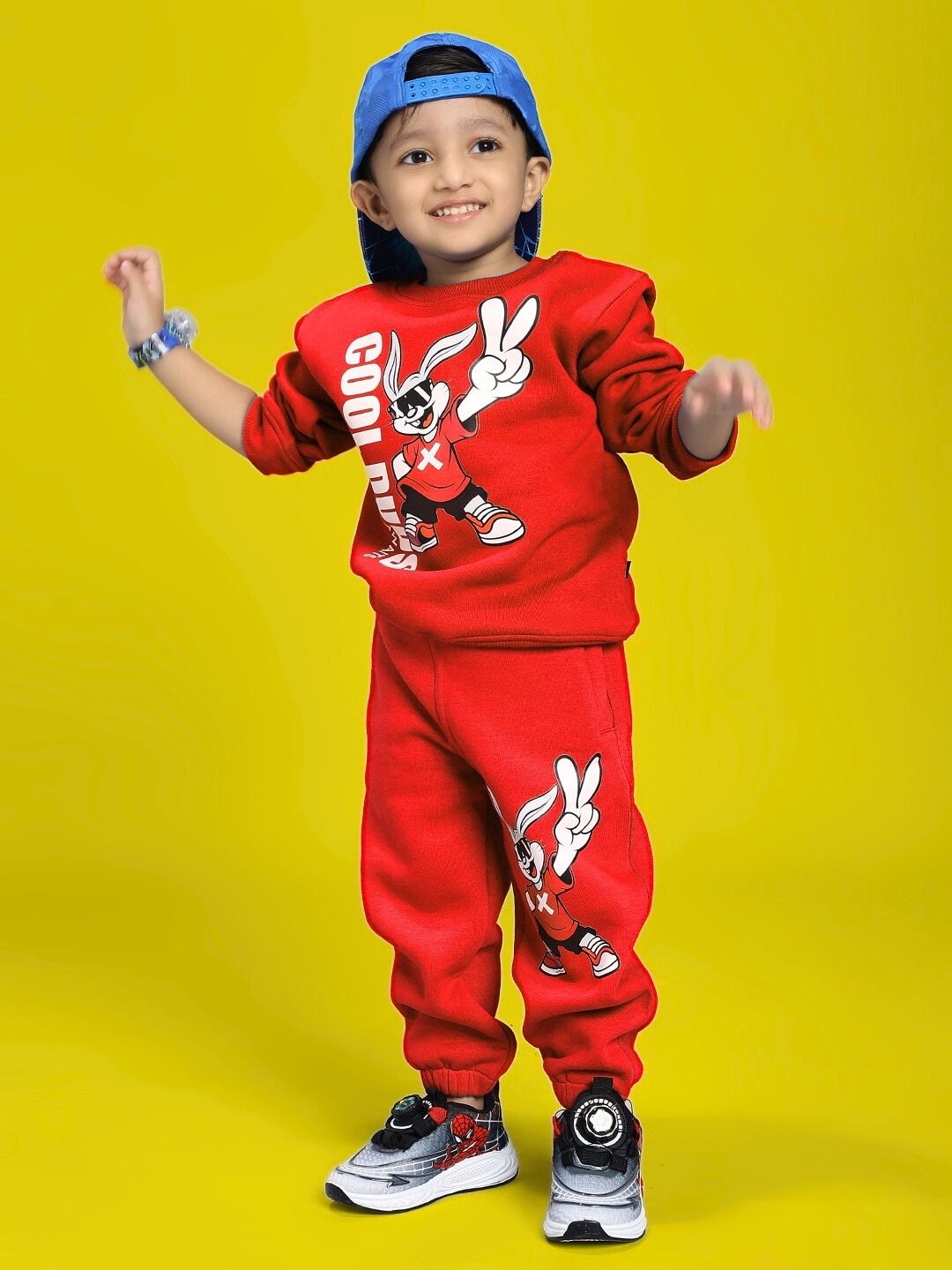 Child wearing the ADVENTURE BUNNY CO-ORD FOR BOYS AND GIRLS RED outfit, featuring playful bunny graphics on a bright yellow background.