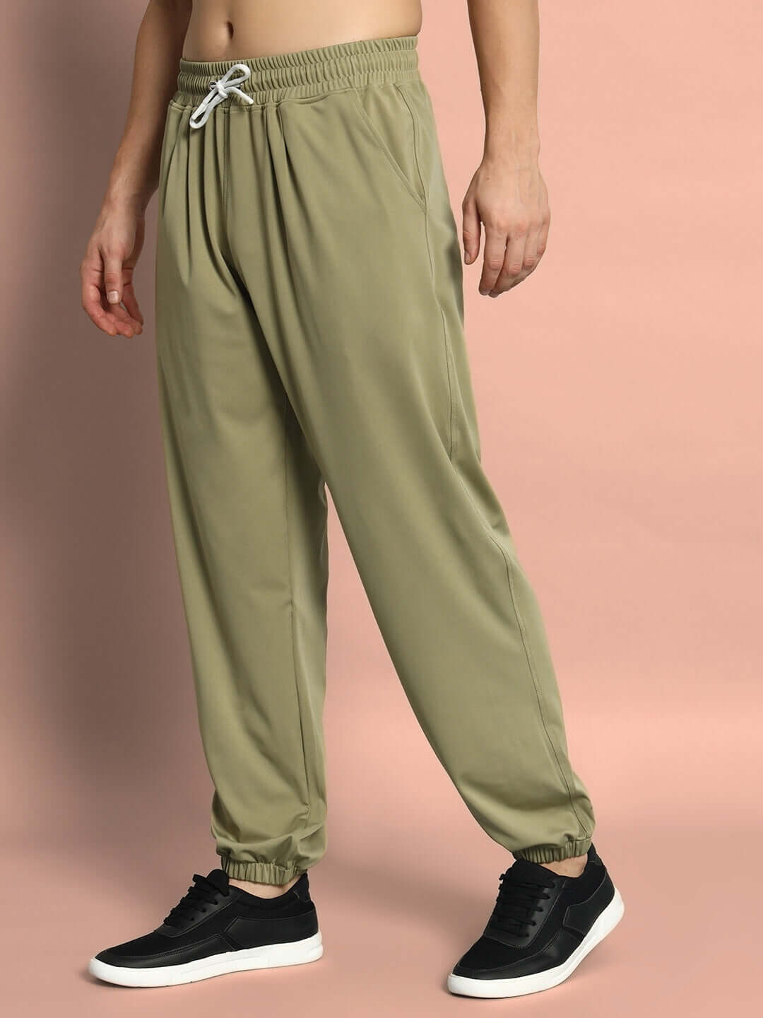 Model wearing olive green agile relaxed pant jogger with elastic waistband, highlighting casual comfort fit.