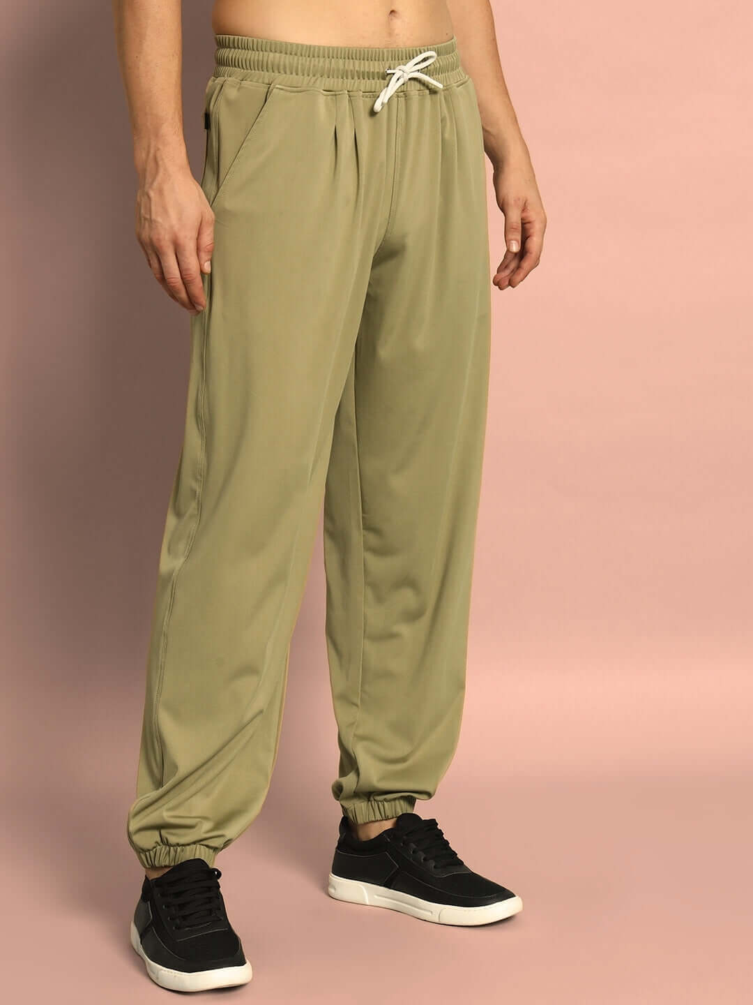 Olive green AGILE RELAXED PANT JOGGER worn by model, showcasing comfortable, tailored fit with elastic waist and cuffs.