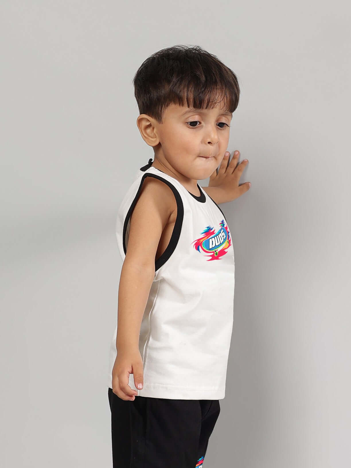 Young child wearing off-white Alien Summer T-shirt for boys & girls, made by DUDS, featuring colorful print and custom fit option.