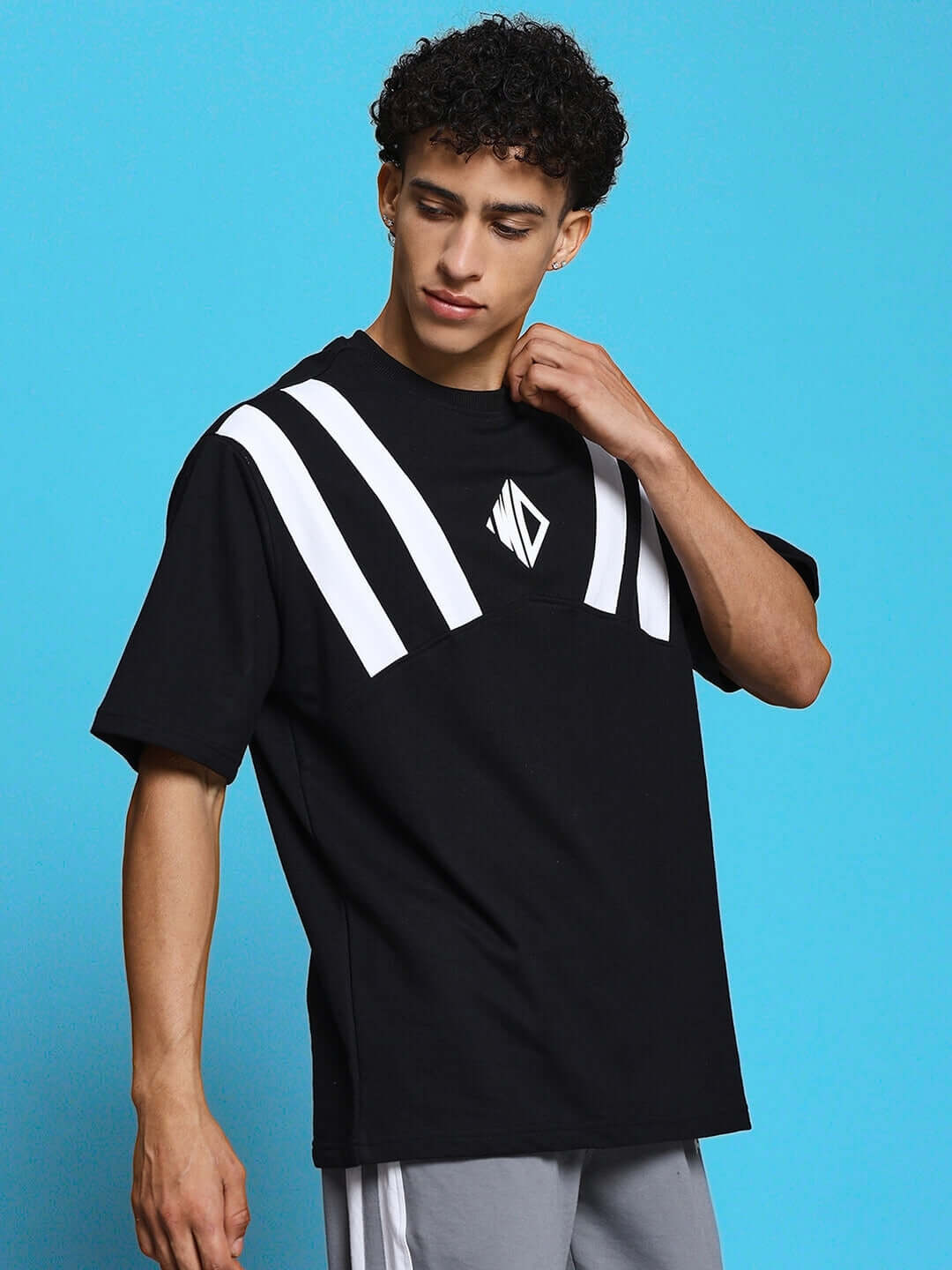 Model wearing Allonzo oversized black T-shirt with white stripes, crafted from premium heavy gauge fabric, by Color By Colours.