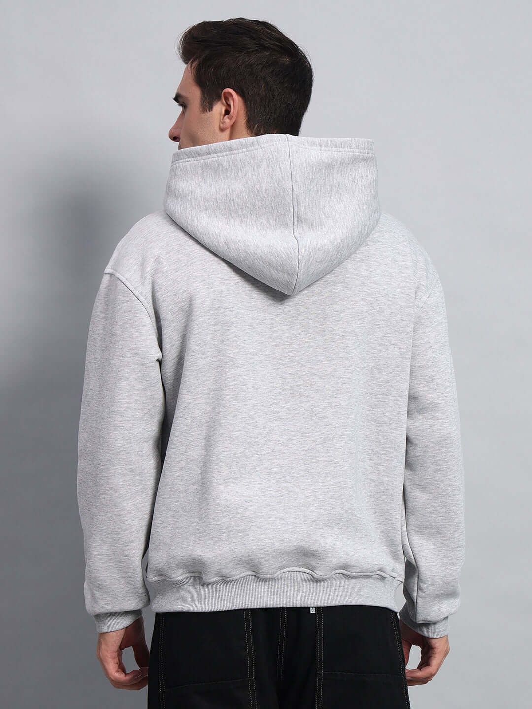 Model wearing AMARILLO FLEECE HOODIE MELANGE GREY from the back, showcasing its design and quality craftsmanship.