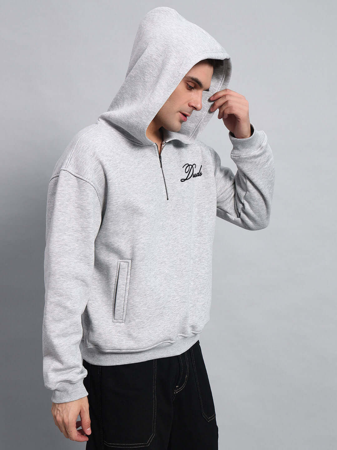 AMARILLO FLEECE HOODIE MELANGE GREY worn by model with hood over head showcasing stylish design and comfort.